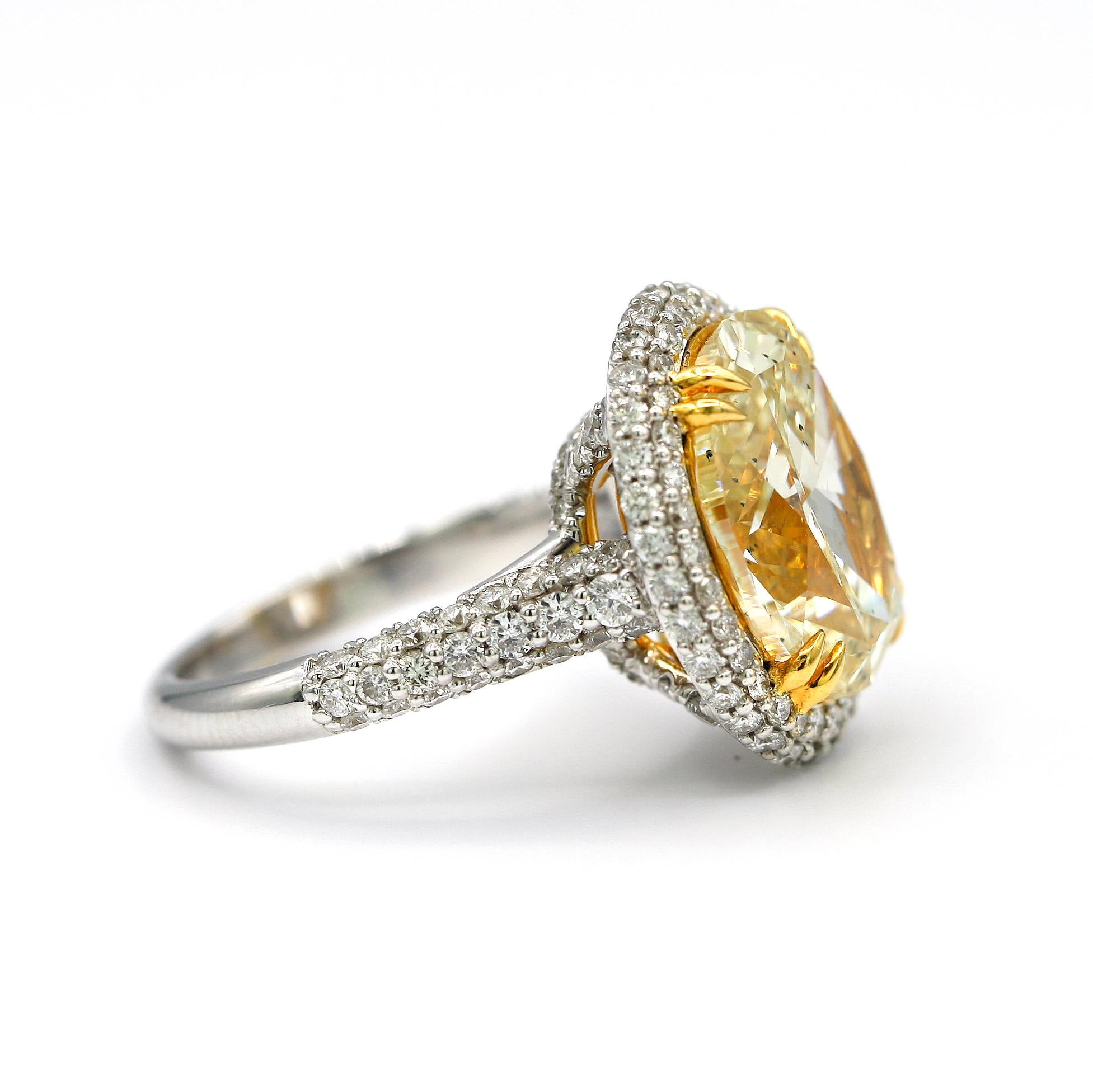 Contemporary 7.36 Carat EGL Fancy Light Yellow Oval SI2 with Pave Diamonds in 18 Karat Ring For Sale