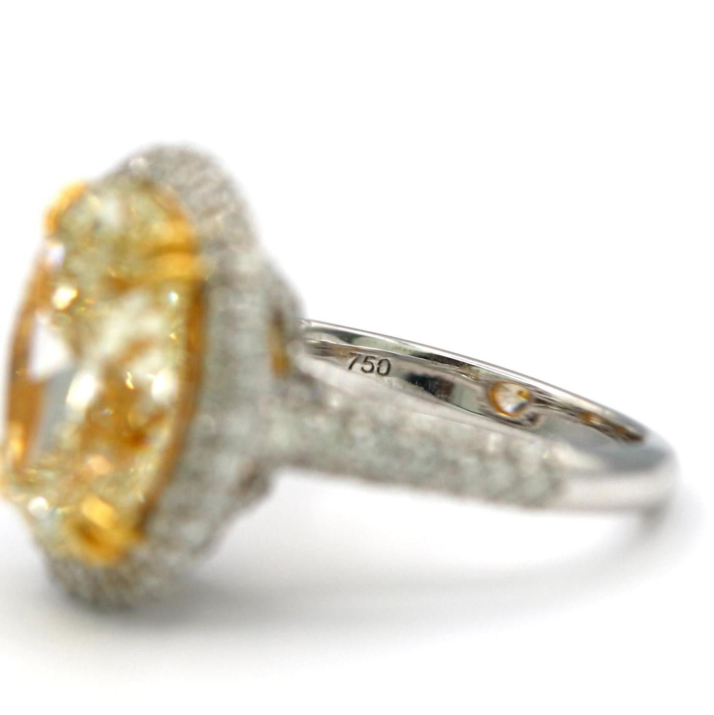 7.36 Carat EGL Fancy Light Yellow Oval SI2 with Pave Diamonds in 18 Karat Ring In New Condition For Sale In Los Angeles, CA