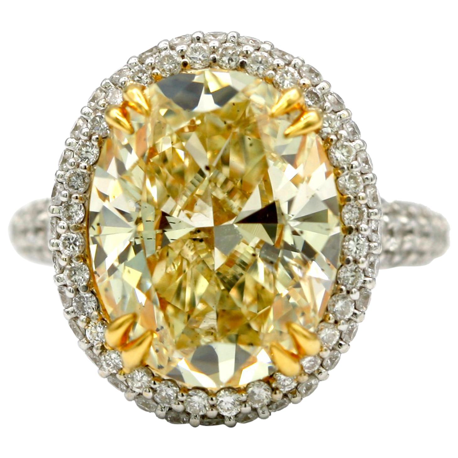 7.36 Carat EGL Fancy Light Yellow Oval SI2 with Pave Diamonds in 18 Karat Ring For Sale