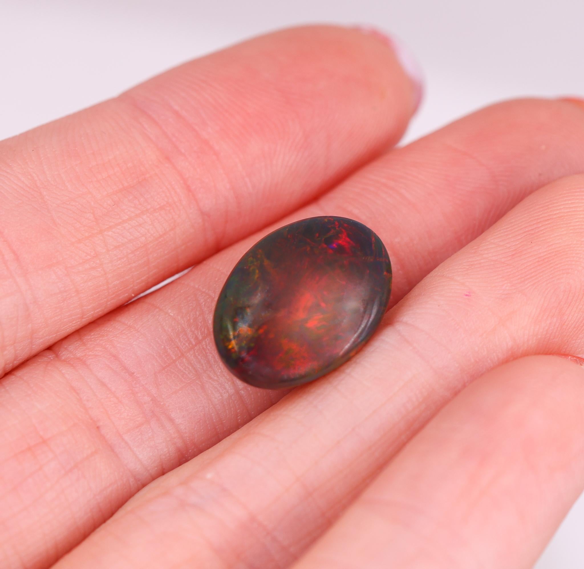 Women's or Men's 7.38 Carat Black Opal Loose Gemstone Oval 16x12mm For Sale