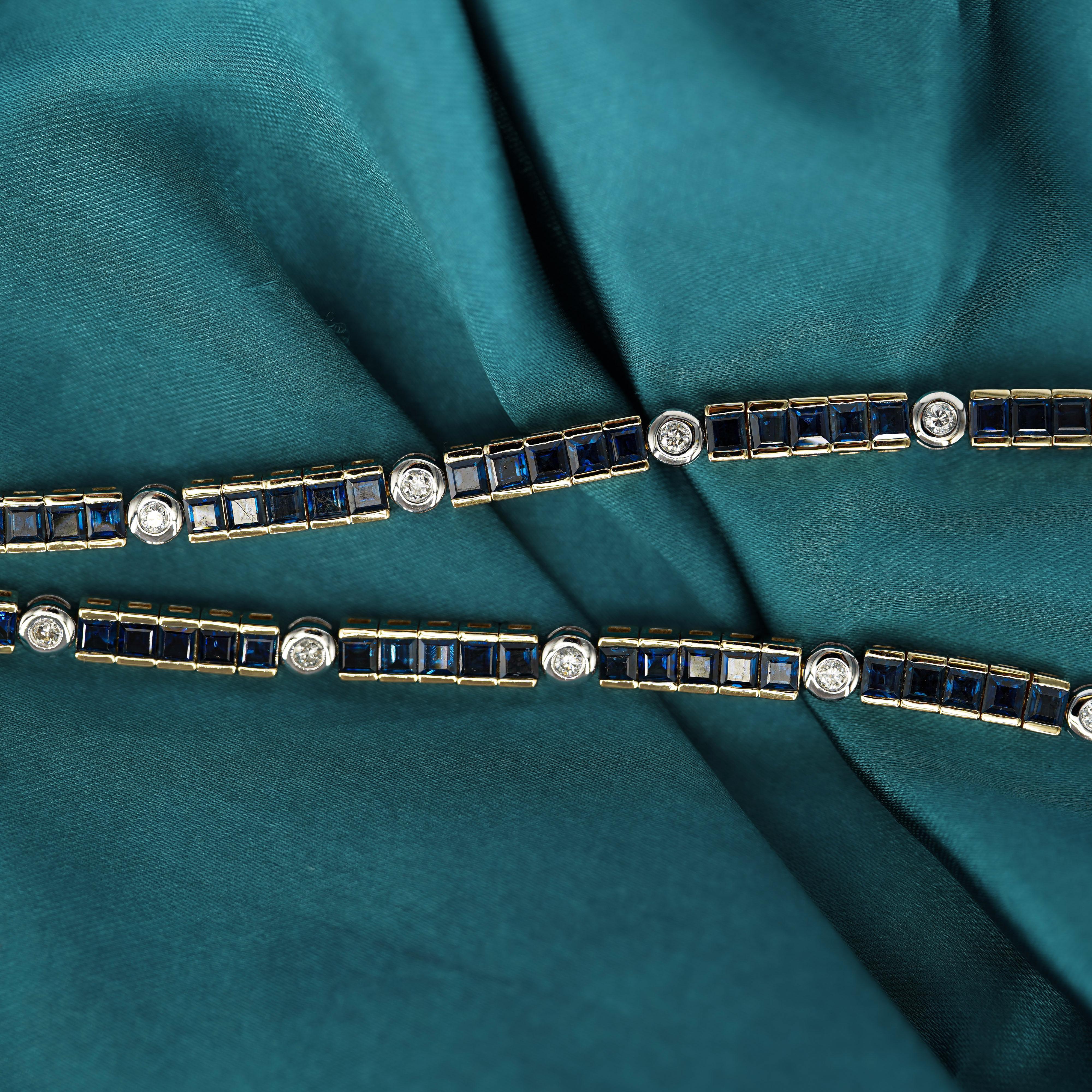 A sophisticated 18K gold two-tone tennis bracelet featuring 49 channel-set square cut blue sapphires and 9 round brilliant cut white diamonds, creating a symmetrical and unique  aesthetic that sits beautifully the wrist.

Details:
Item Type: Tennis