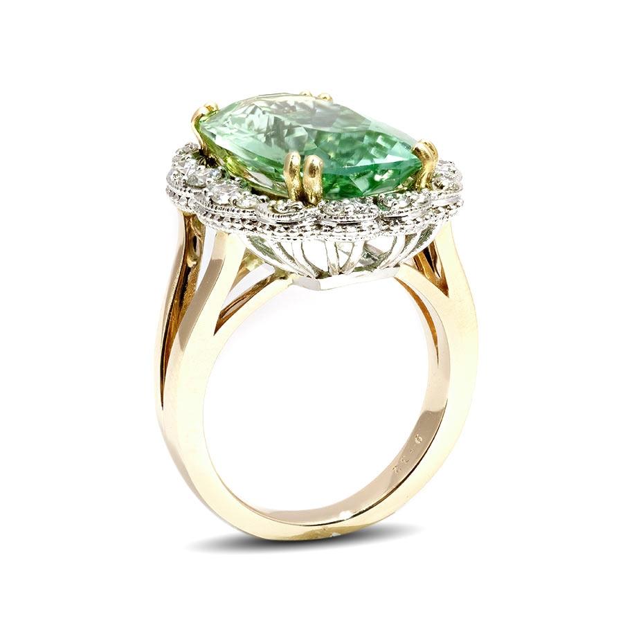 Mined in Namibia, this 7.38 carat stunner will have heads turning. A soft mint green that encapsulates the gemstone stands out because of its size and eye clean appearance. Accentuated by diamonds that creates a flower in its design, this 14K white