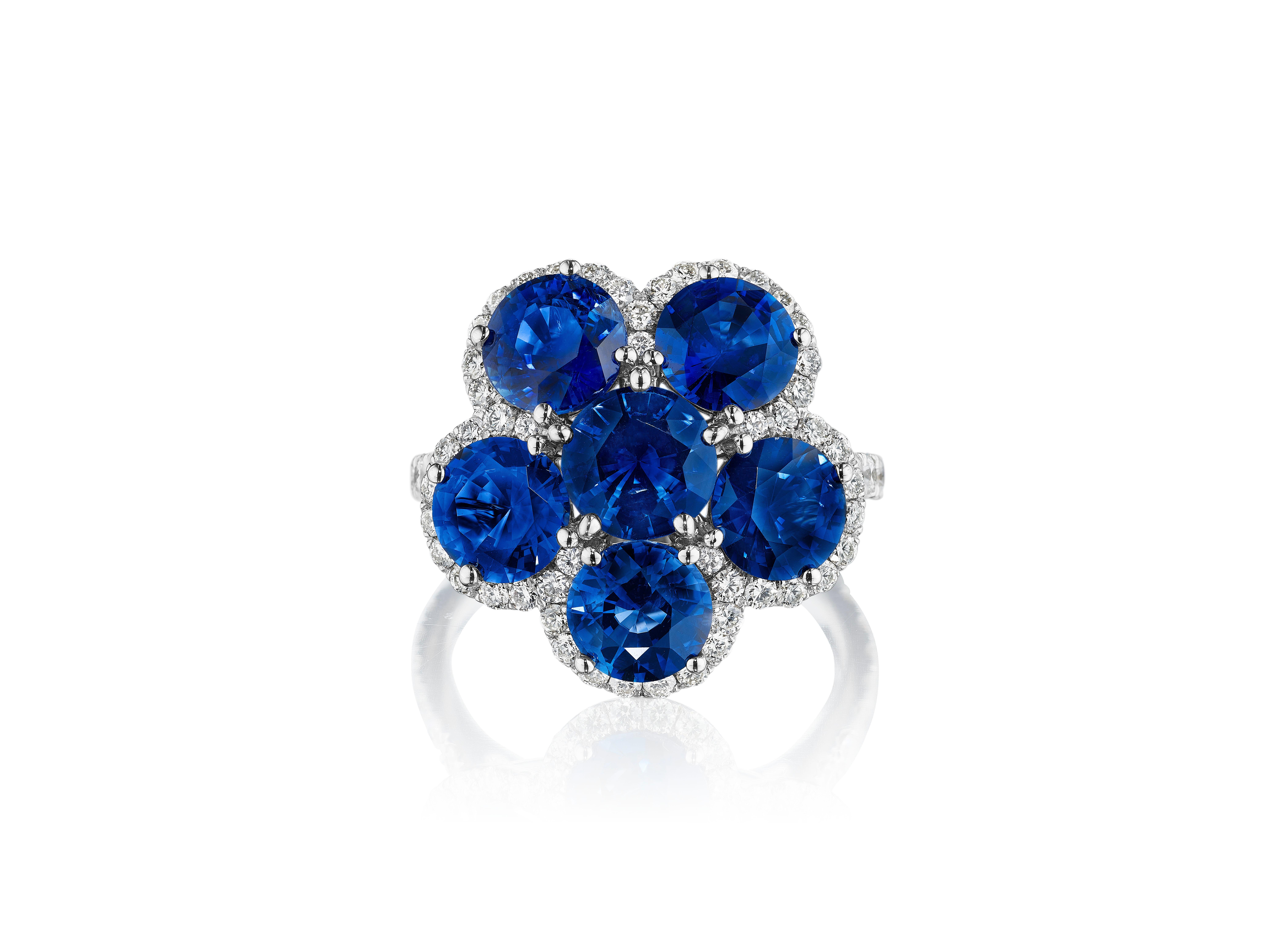 •	18KT White Gold
•	Size 6.5
•	7.38 Carats

•	Number of Round Sapphires: 6
•	Carat Weight: 6.39ctw

•	Number of Round Diamonds: 70
•	Carat Weight: 0.99ctw

•	A piece inspired by the elegance and beauty of the natural environment. 6 royal blue