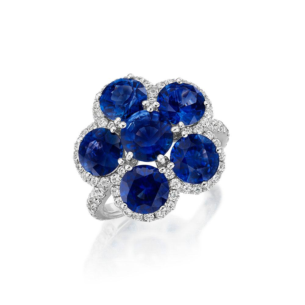 •	18KT White Gold
•	Size 6.5
•	7.38 Carats

•	Number of Round Sapphires: 6
•	Carat Weight: 6.39ctw

•	Number of Round Diamonds: 70
•	Carat Weight: 0.99ctw

•	A piece inspired by the elegance and beauty of the natural environment. 6 royal blue