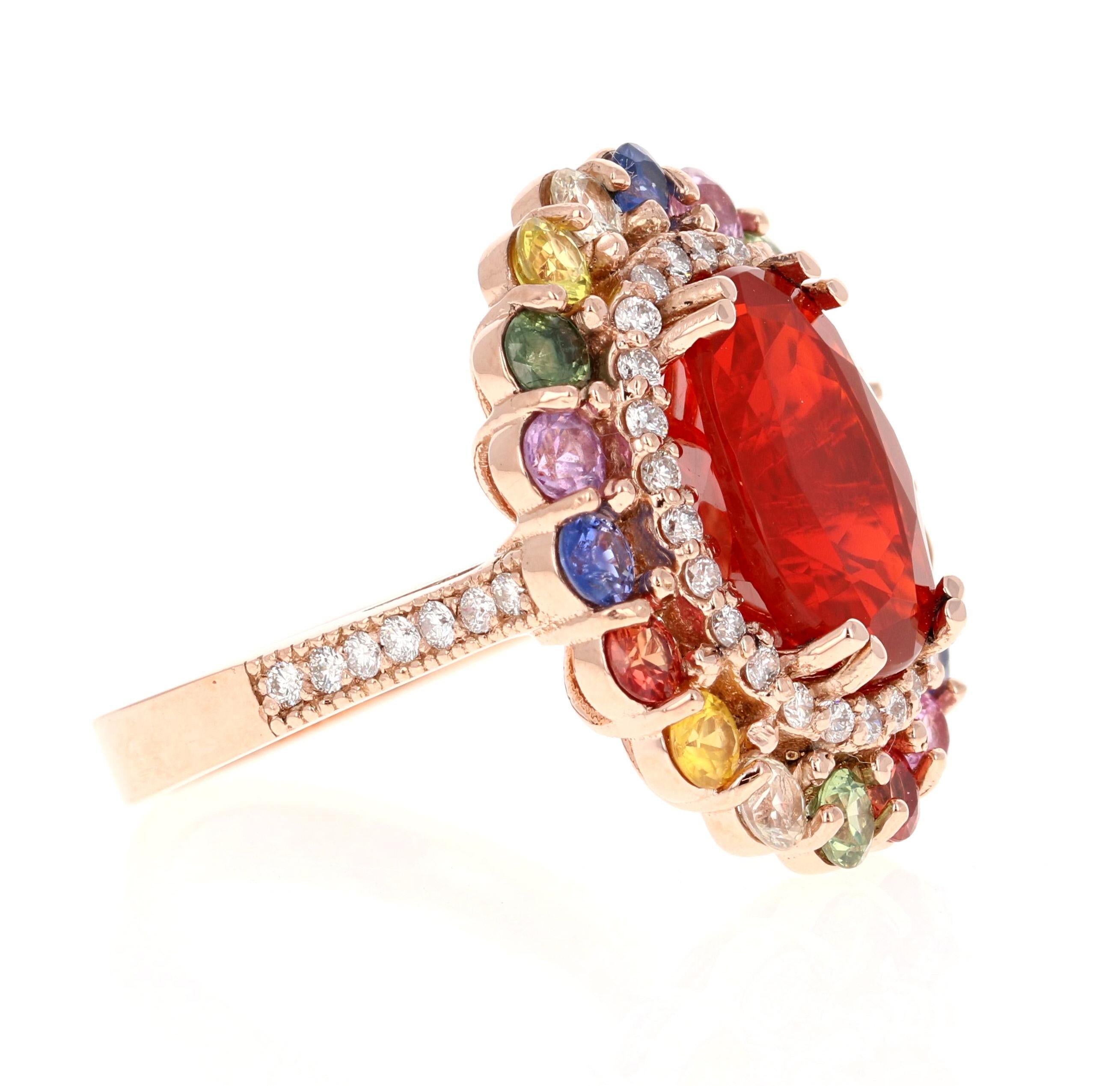 This eye-catching cocktail gemstone ring showcases a stunning 4.35 Carat Oval Cut Natural Red Fire Opal as its centerpiece. Surrounding the fiery opal are 2.52 carats of vibrant Round Cut Natural Rainbow Sapphires, beautifully accented by Natural