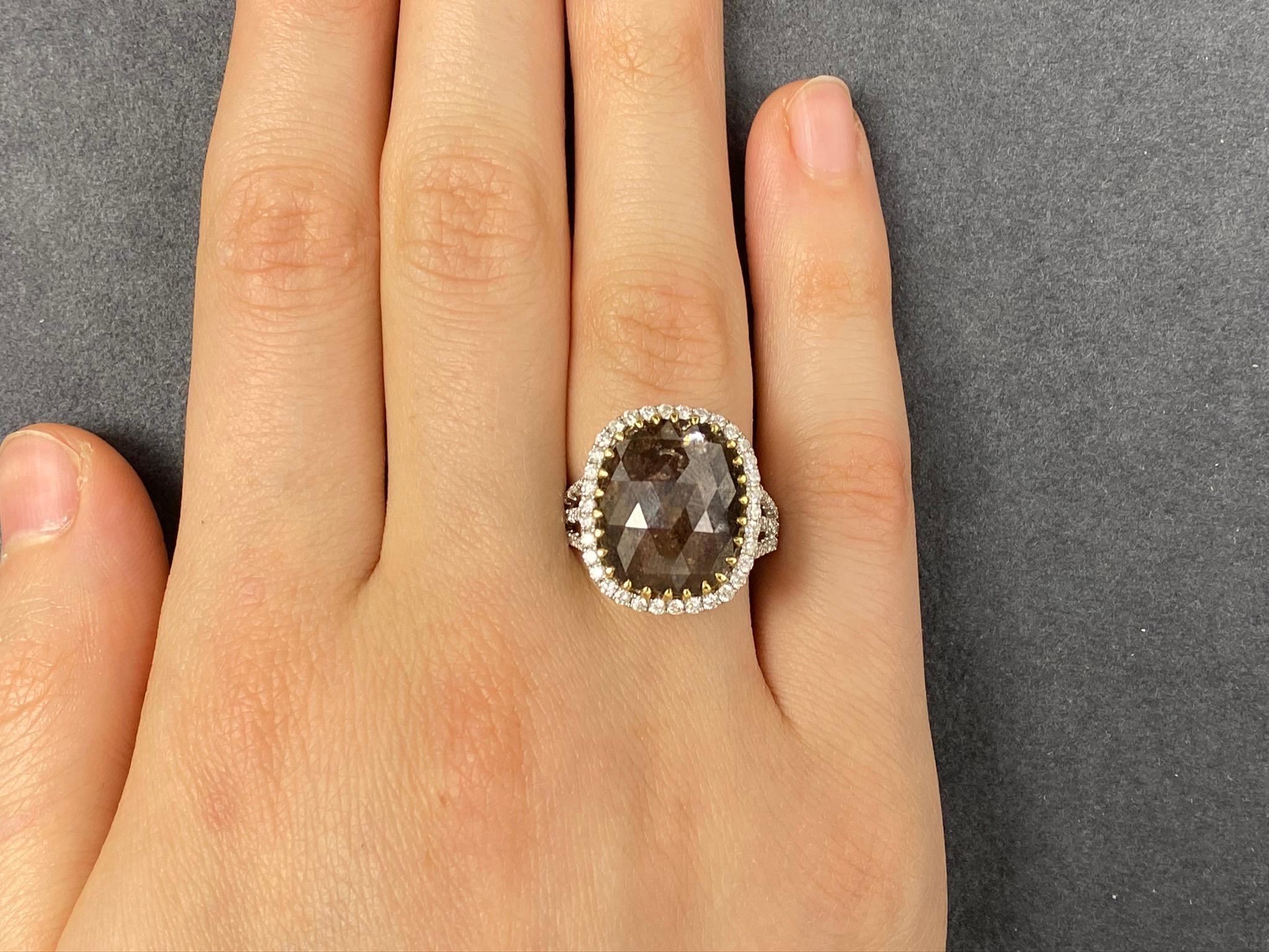 This stunning Cocktail Ring features a beautiful 7.39 Carat Rose Cut Cushion Brown Diamond, with a Diamond Halo. The Brown Diamond sits on a Triple Diamond Shank. 

This ring is set in 18K White Gold, with 18K Yellow Gold prongs on the center