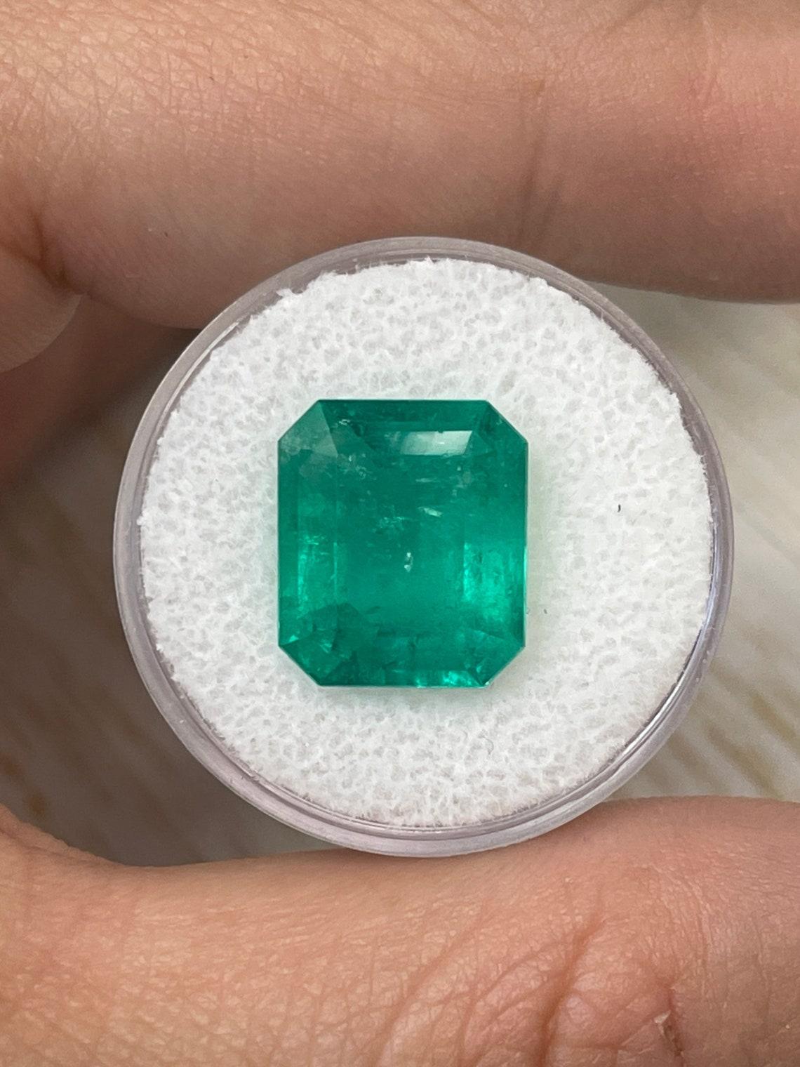 Stone: Emerald
Weight: 7.39-carats
Shape: Emerald Cut
Clarity: Transparent
Luster: Very Good
Color: Bluish Green
Measurements: 13.54mm x 11.71mm x 7.01mm
Geographic Origin: Colombia
Treatment: Natural, Oiling

Comments: Due to their growth