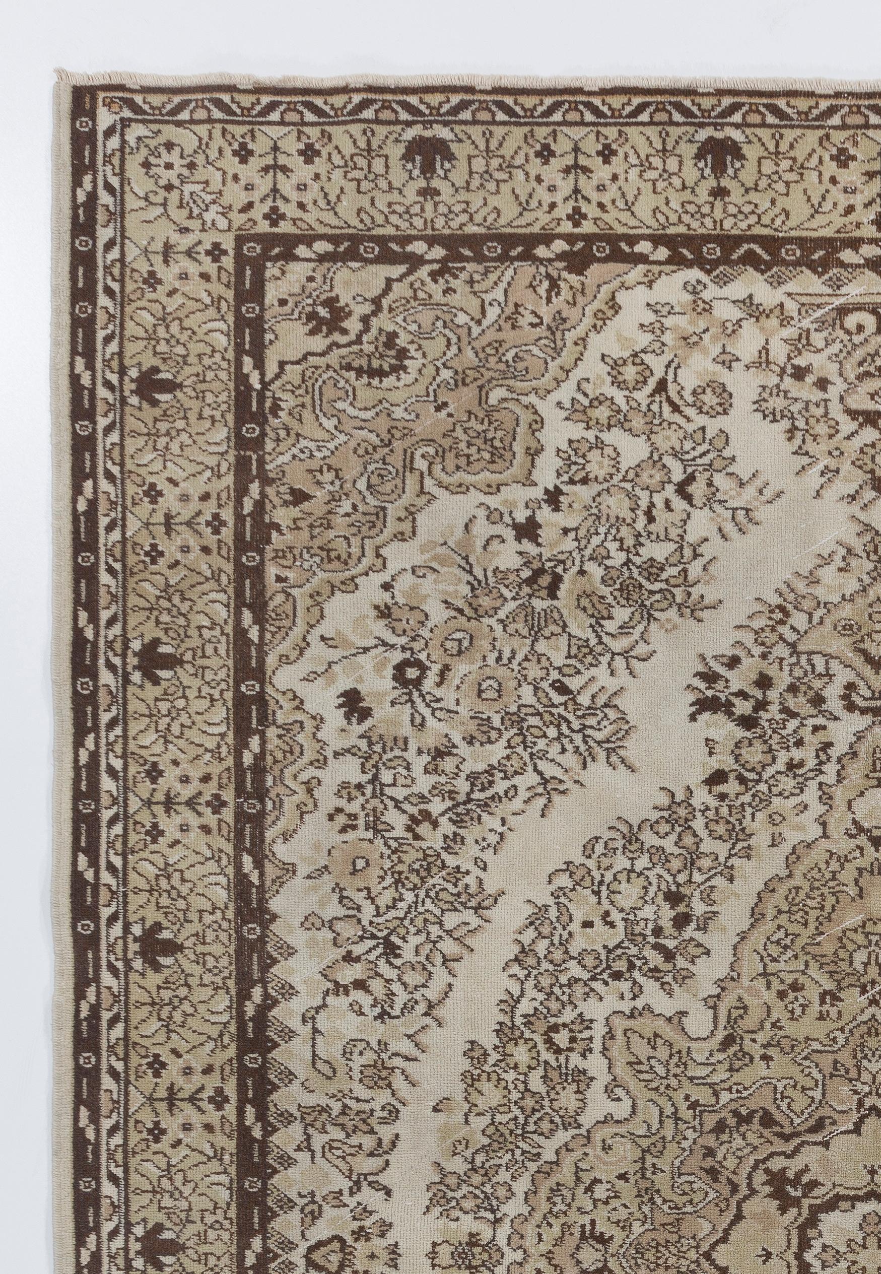 A vintage hand-knotted Turkish area rug with an elaborately decorated design of a central medallion against a two-layered field filled with strolling leafy vines with palmette heads in fine gradations of neutral tones of ivory, beige, light taupe