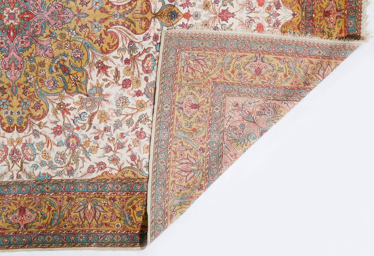 An exquisite silk Turkish Kayseri medallion rug in a vibrant and subtle color palette with powerful and clearly defined outlines coming together to create a naturally moving scene of flowing stems, undulating flower heads and meandering vines. A