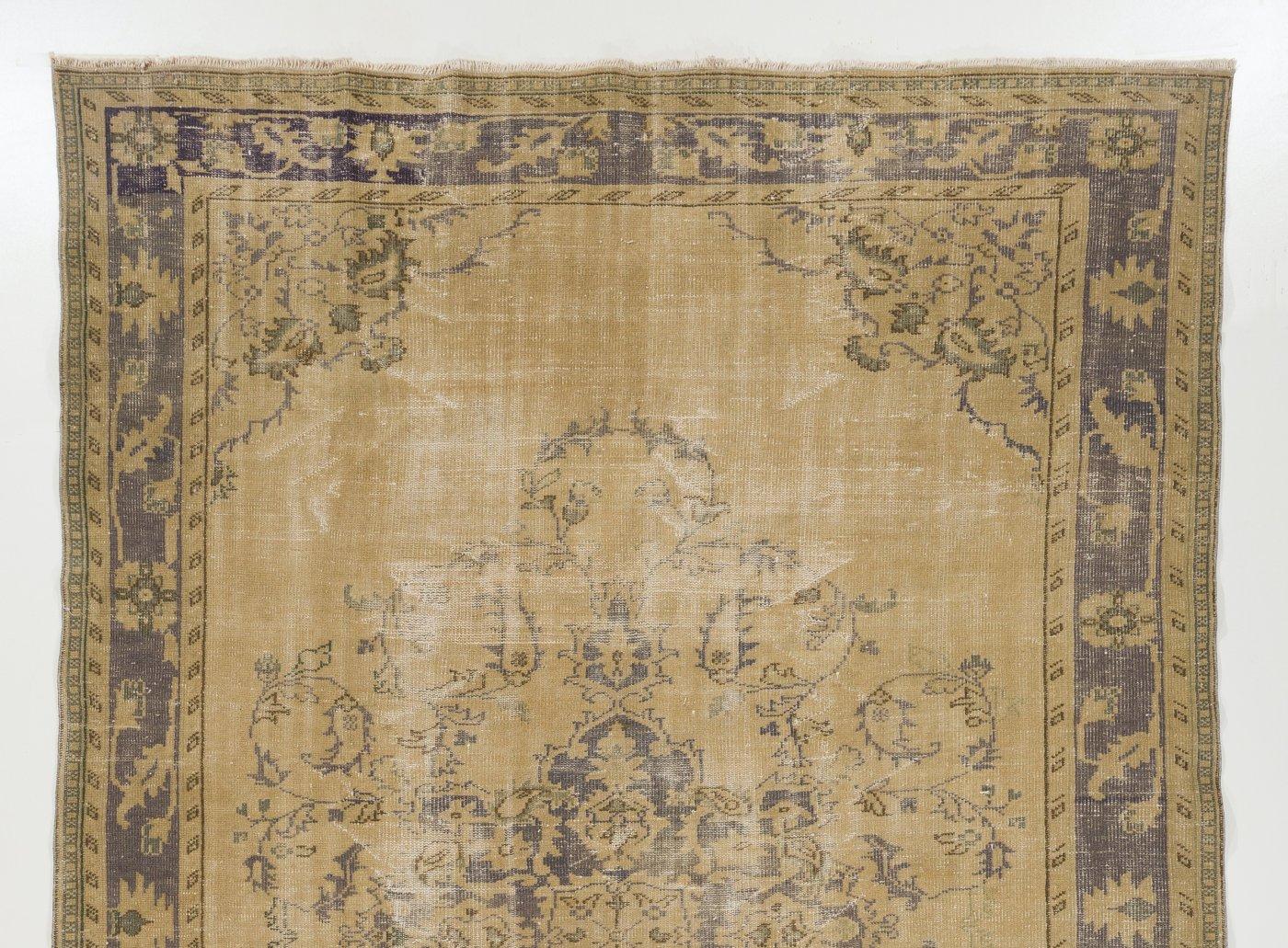 A finely hand-knotted vintage Turkish carpet from 1960s featuring an elegant medallion design in sand beige and taupe colors. The rug has low wool pile on cotton foundation. It is heavy and lays flat on the floor, in very good condition with no