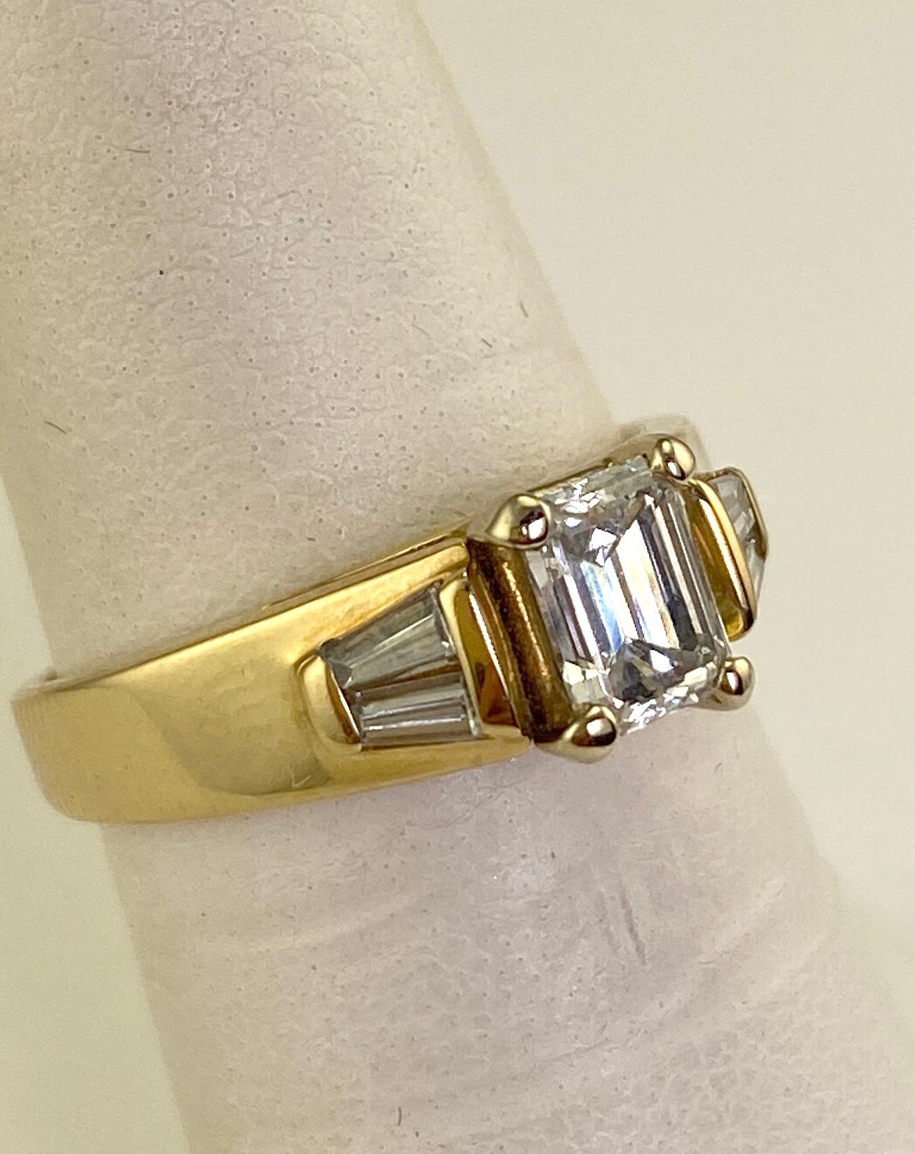 Contemporary .74 Carat Natural Emerald Cut Diamond Ring w/ Baguette Diamonds 1.0 CTW. 14K Y/G For Sale