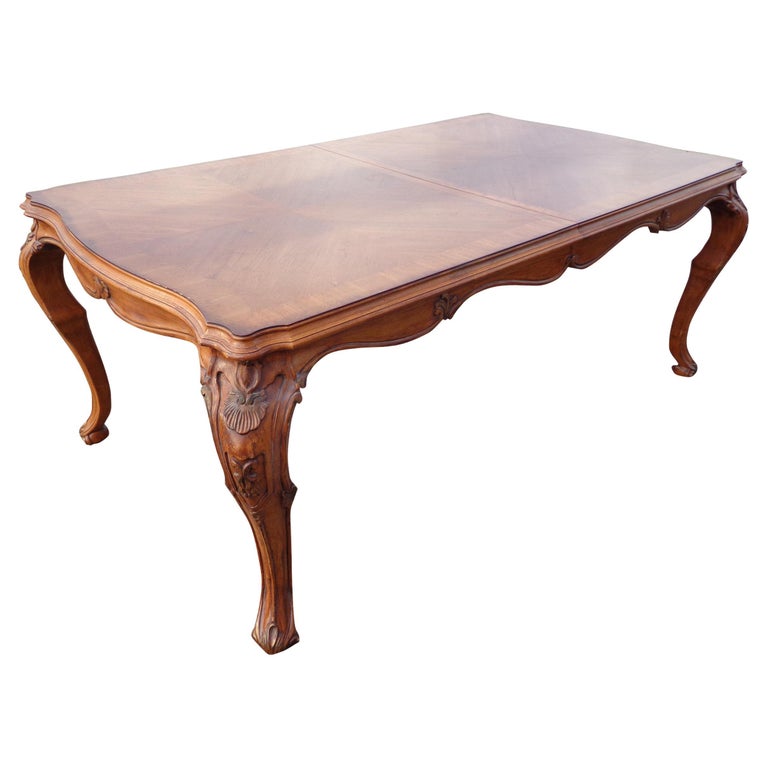 French Louis XV style draw leaf table 

French Rococo style parquet top with serpentine apron and rocaille decoration on the cabriole legs. The table features 2 leaves that can expand the table from 74? to 114?.
     