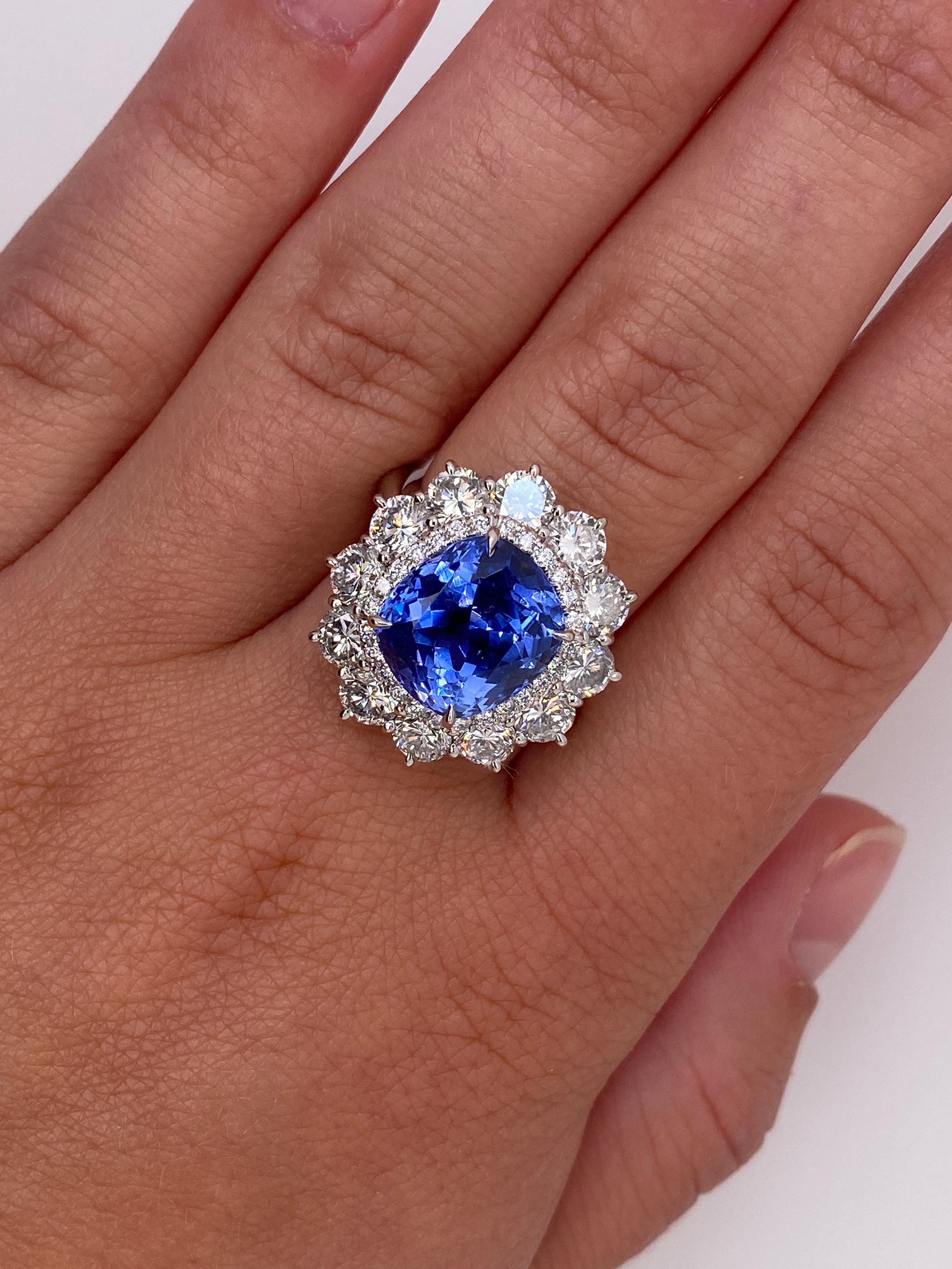 7.40 carat cushion blue sapphire (NH) with 12 round diamonds 2.92 carats and .21 carats of round melee diamonds set in a platinum ring. Size 7