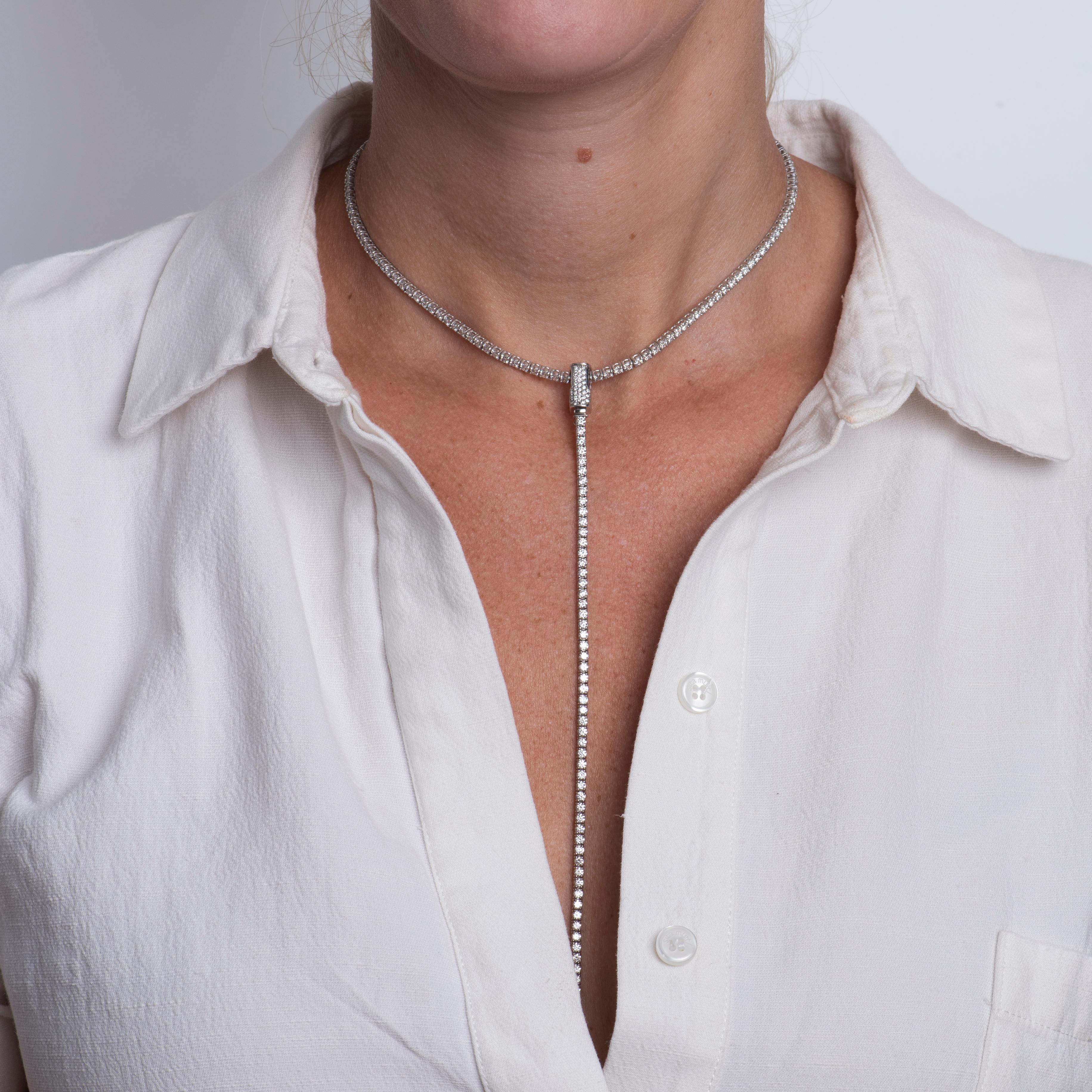 This unique design was crafted in house by our master jewelers and can be worn multiple ways. It features 7.40 carat total weight in natural round diamonds set in 14 karat white gold. The 11 inch tennis necklace is adjustable up to 16