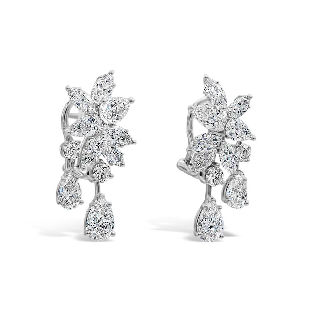 A beautiful and chic pair of drop earrings showcasing two GIA certified diamonds suspended on a dangle cluster of brilliant mixed cut diamonds, set in an intricate and stylish drop design. Diamonds weigh 7.45 carats total and are approximately D-F