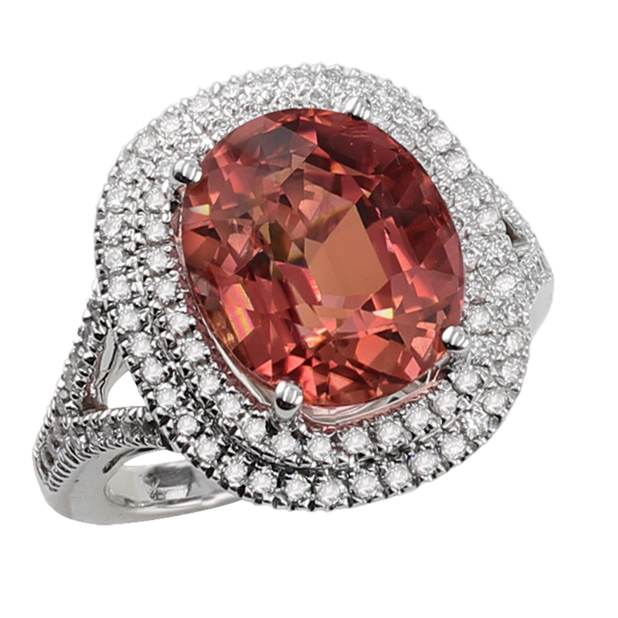 7.41 carat pretty-in-peach cushion tourmaline ring, set in 18K, split shank surrounded by a double halo of 0.63 carat diamonds. 

Pink and Peach tourmaline are said to carry healing energies and spiritual wisdom based on compassion, the heart and