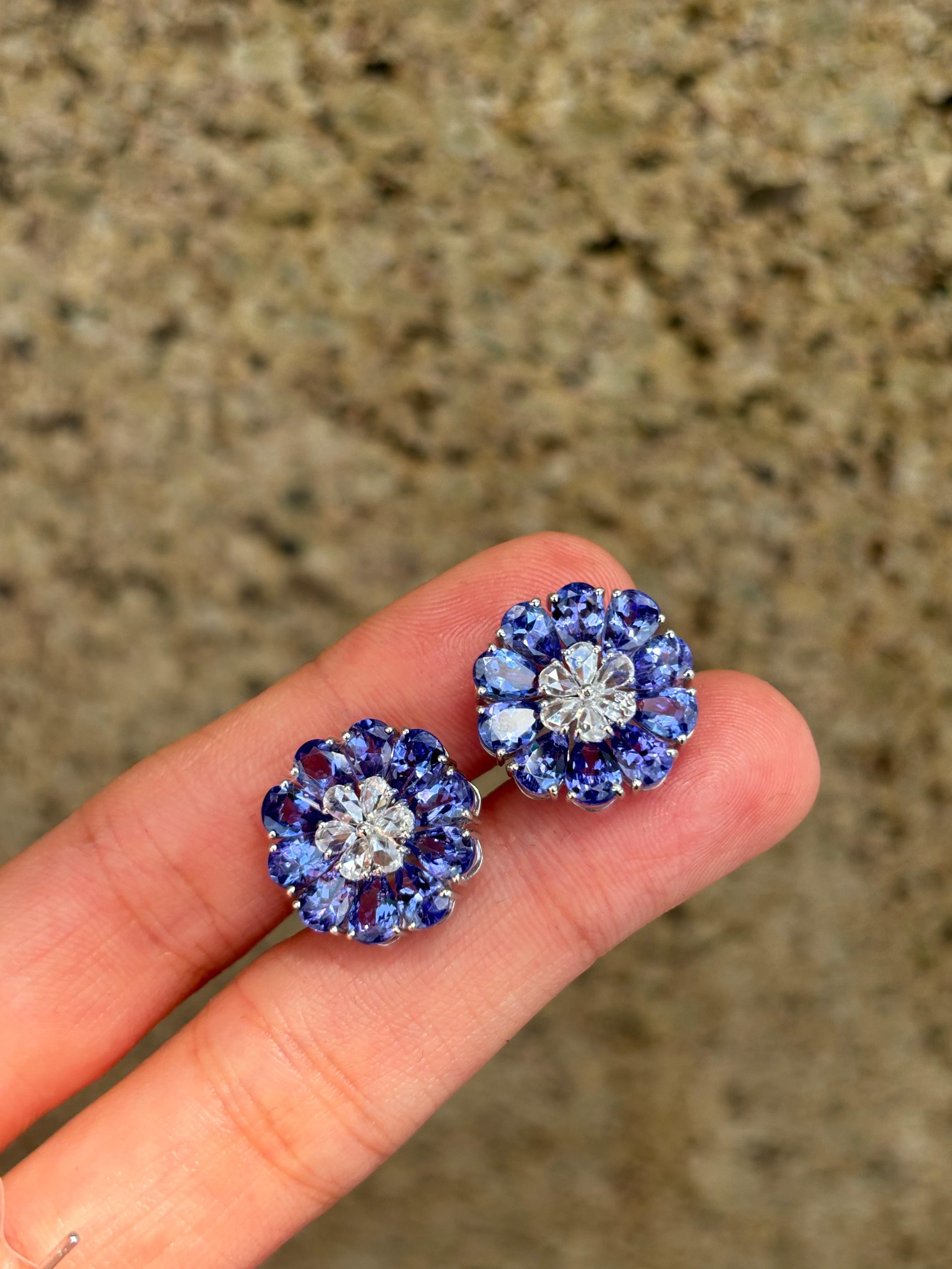 A pair of beautifully crafted 7.41 carat pear shaped Tanzanite and 0.65 carat pear shaped rose cut white Diamonds studs. The Tanzanites are transparent, and have great shine and luster. The earrings are set in solid 18K White Gold, and come with a