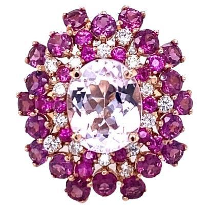 Kunzite Sapphire Diamond Rose Gold Cocktail Ring

This beautiful ring has an Oval Cut Kunzite weighing 3.69 carats and is surrounded by 20 Round Cut Garnets that weigh 2.84 carats along with 15 Pink Sapphires that weigh 0.51 carats. The ring is