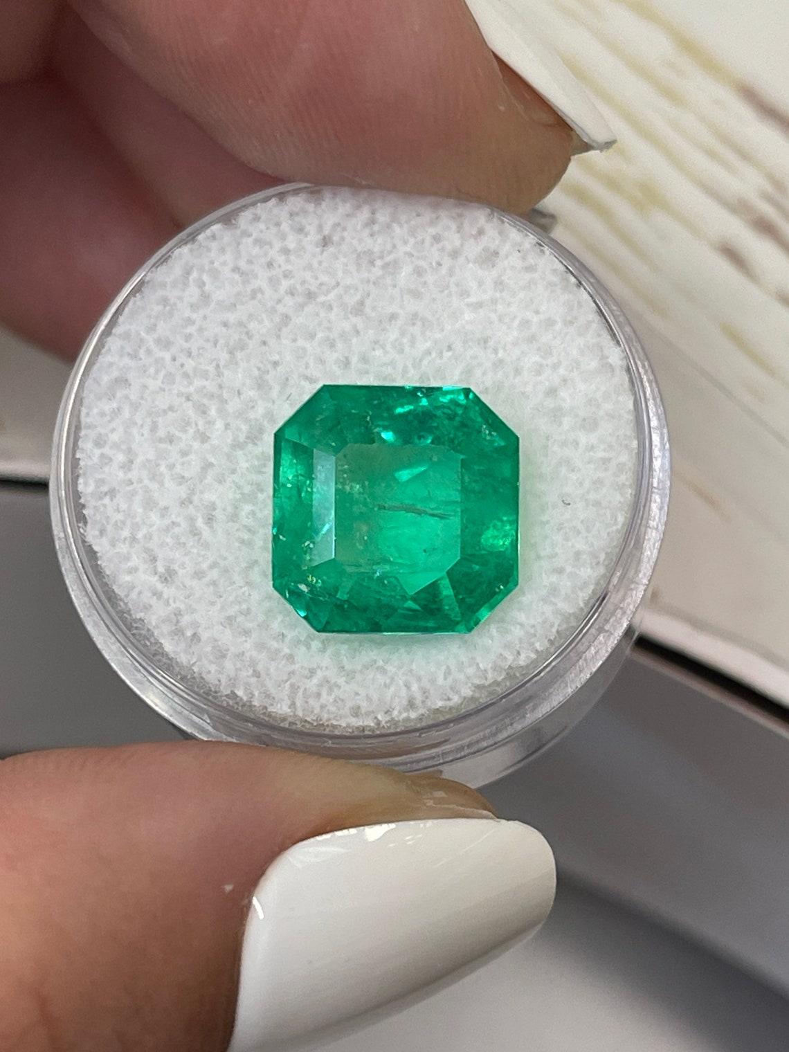 Stone: Emerald
Weight: 7.41-carats
Shape: Asscher Cut
Clarity: Transparent
Luster: Excellent
Color: Vivid Green
Measurements: 11.6mm x 11.5mm
Geographic Origin: Colombia
Treatment: Natural, Oiling

Comments: Due to their growth conditions in nature