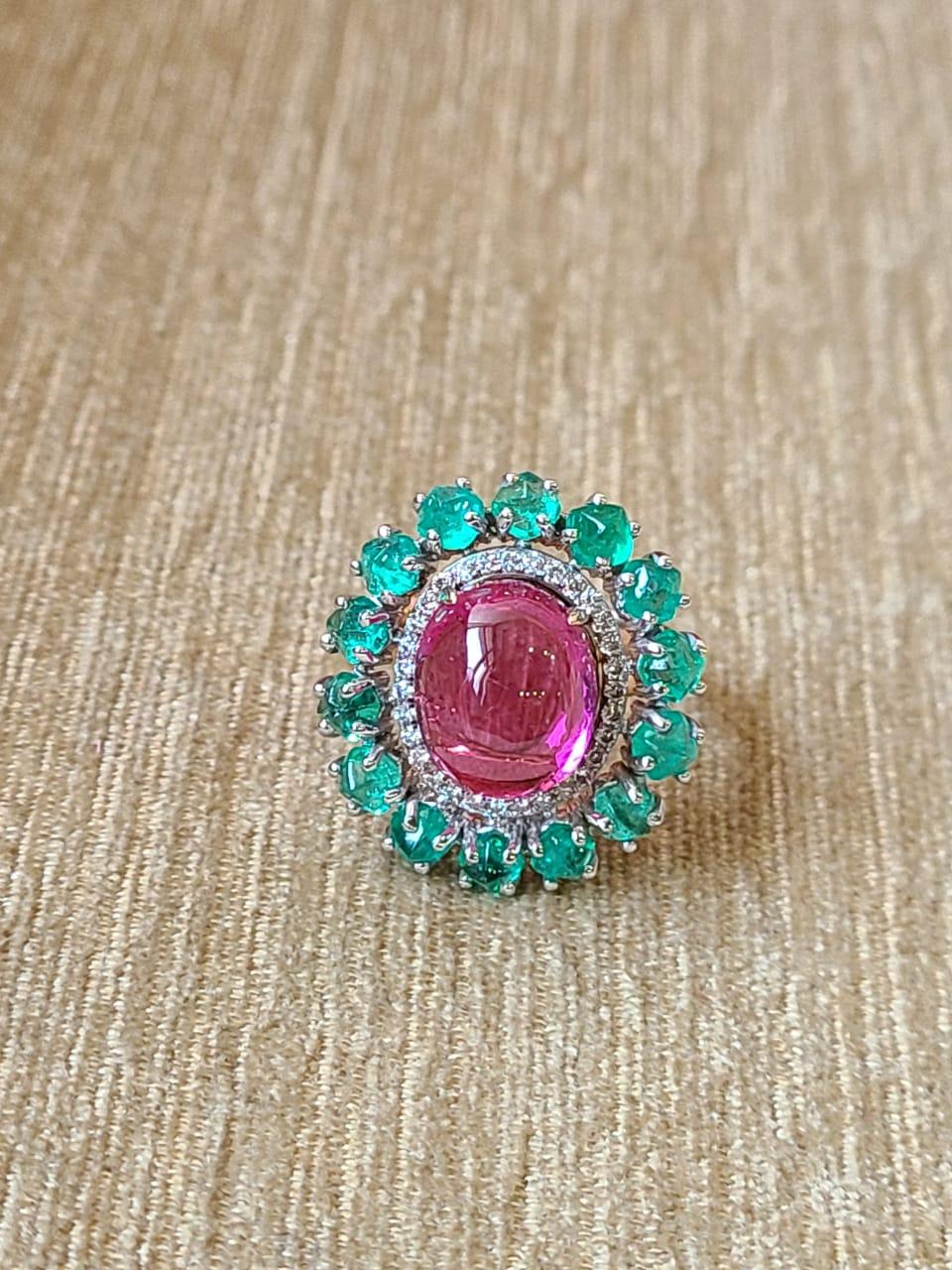 A very gorgeous and one of a kind, Rubellite & Emerald Cocktail / Dome Ring set in 18K Gold & Diamonds. The weight of the Rubellite is 7.42 carats. The weight of the Emerald is 2.99 carats. The Emerald is completely natural, without any treatment &