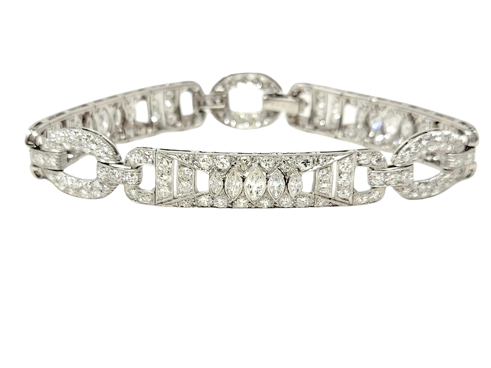 This absolutely stunning diamond and platinum bracelet exudes elegance and glamour, with a touch of Old World sophistication. This unique piece features assorted shaped open platinum links with ornate milgrain detailing throughout. The polished