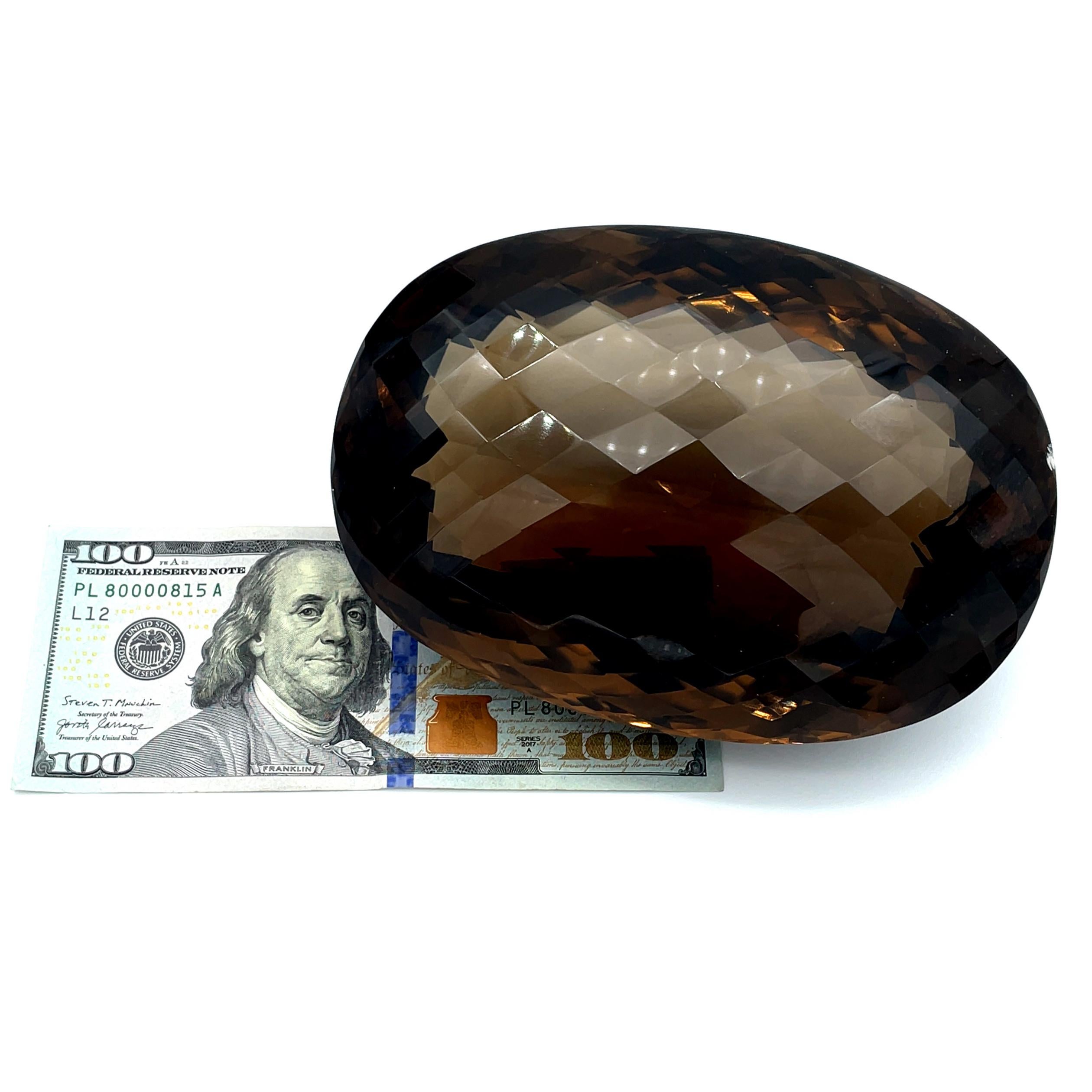 Rarely is a jewel large enough to be weighed in pounds, yet this exquisite specimen weighs 3.276 pounds! A real conversation starter and preeminent example of the earth's ability to create miracles! This oval faceted smoky quartz is absolutely