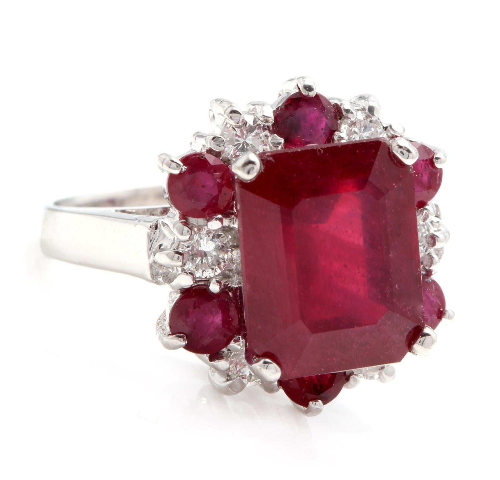7.45 Carats Impressive Natural Red Ruby and Diamond 14K White Gold Ring

Total Emerald Cut Center Red Ruby Weight is Approx. 6.00 Carats (Lead Glass Filled)

Center Ruby Measures: Approx. 10.00 x 8.00mm

Side Natural Rubies Weight is: Approx. 1.05