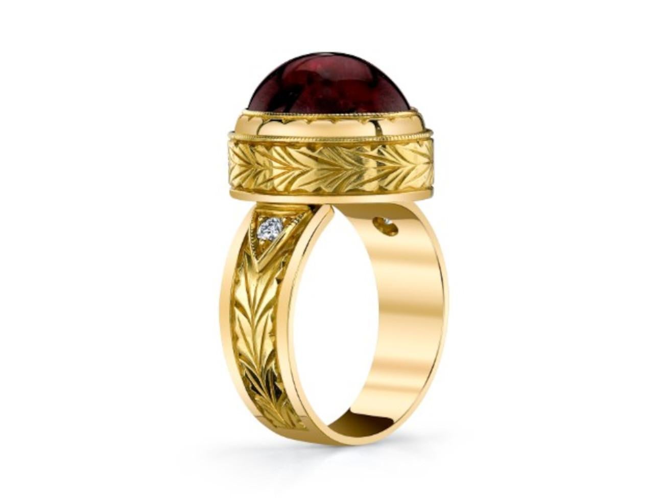 This 18k yellow gold handmade ring features a beautifully crystalline rubellite tourmaline cabochon with gorgeous raspberry color and excellent clarity. Our signature ring style was designed to showcase a main gemstone of noteworthy quality by