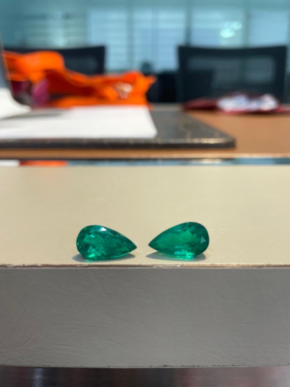 This extraordinary pair of Colombian emeralds, certified by GRS (GemResearch Swisslab), embodies the pinnacle of natural beauty and craftsmanship. Weighing a total of 7.48 carats, these pear-shaped emeralds showcase the vibrant green hue that