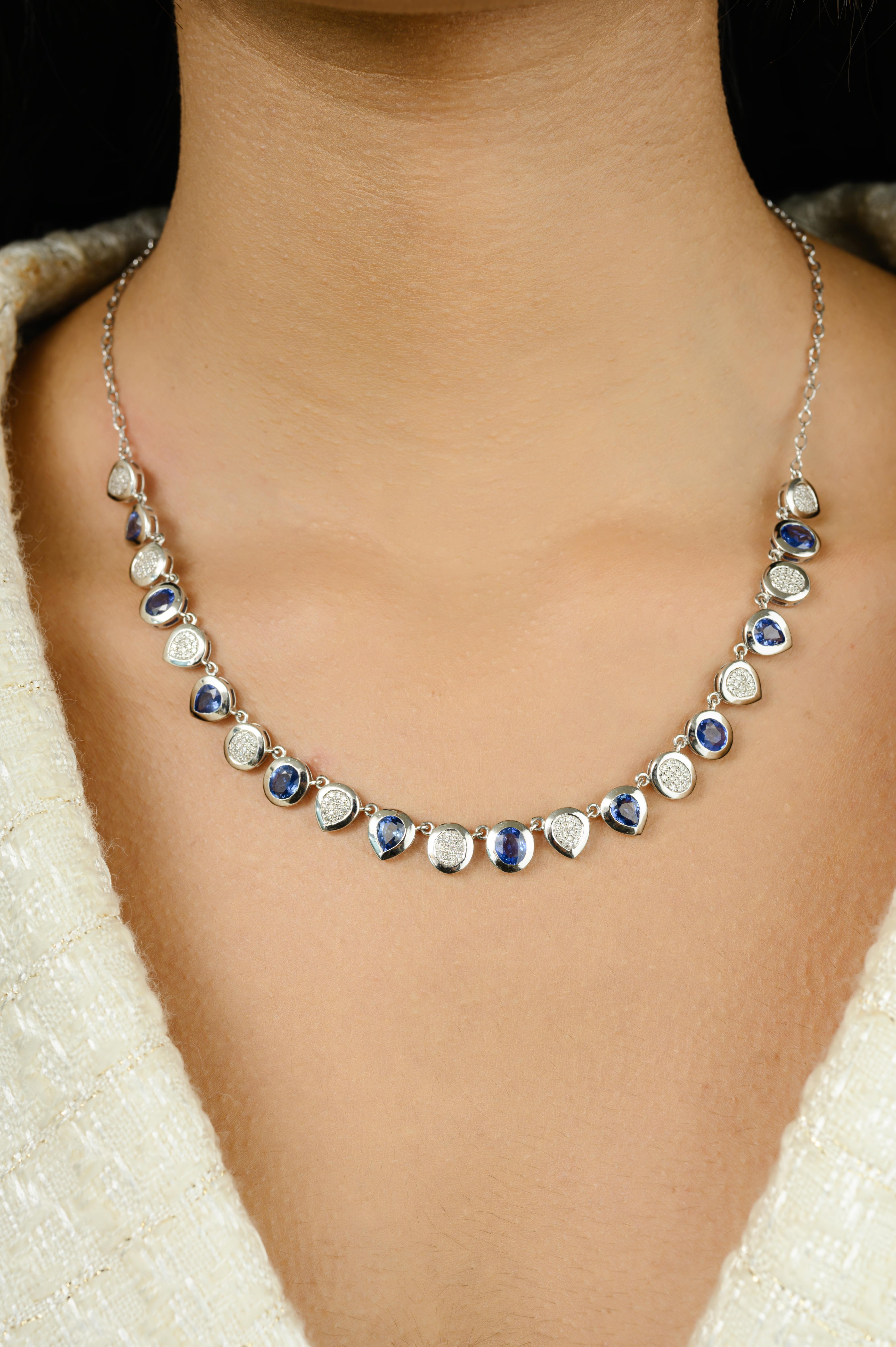 7.48 CT Natural Blue Sapphire Diamond Cluster Chain Necklace in 14K Gold studded with pear and round cut blue sapphire and round cut diamonds. This stunning piece of jewelry instantly elevates a casual look or dressy outfit. 
Sapphire stimulate