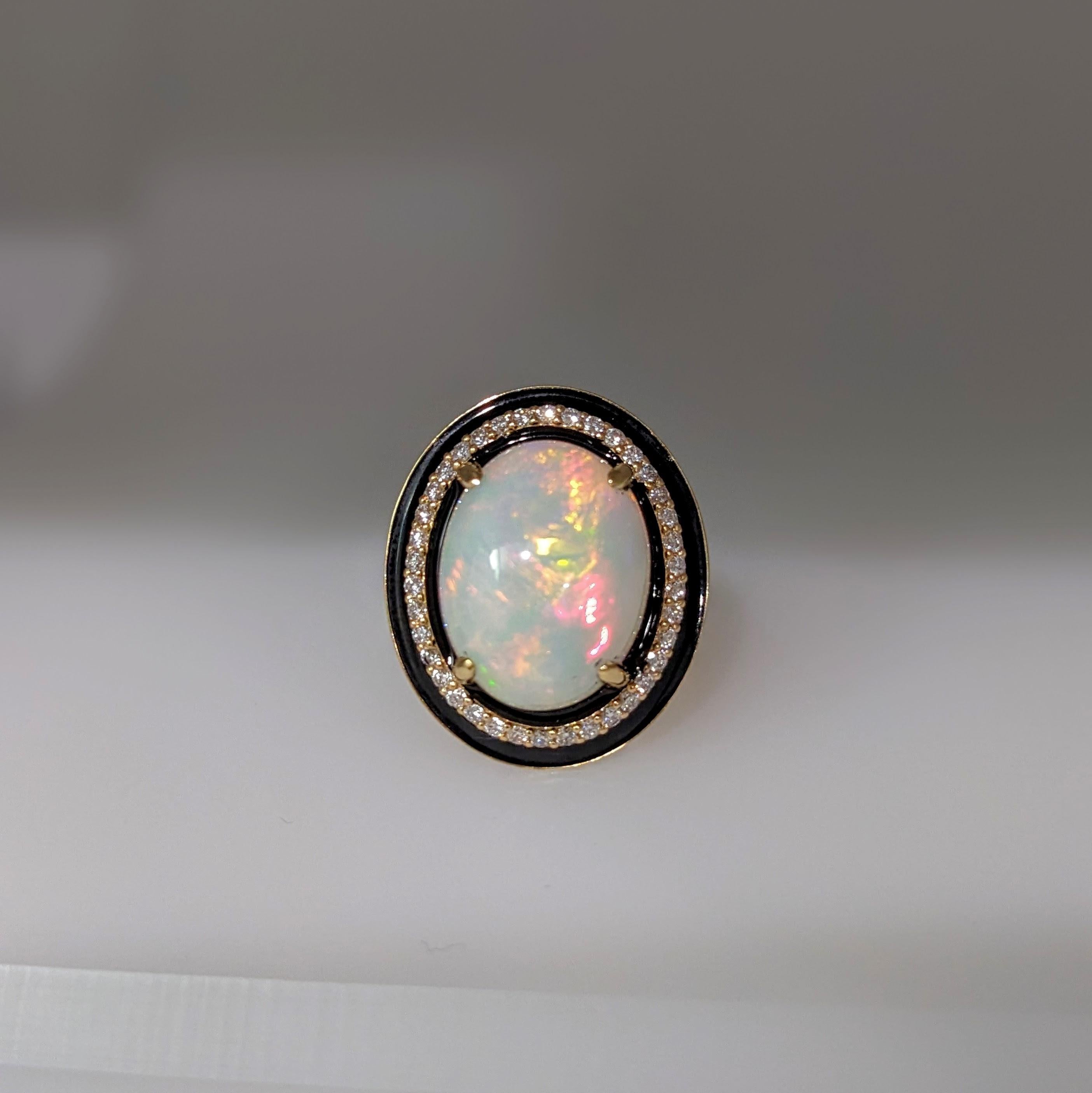 This statement ring features a 7.49 carat oval opal gemstone of size 16x12 mm with a halo of natural earth mined diamonds and black enamel detail, all set in solid 14K gold. This ring can be a beautiful October birthstone gift for your loved ones!