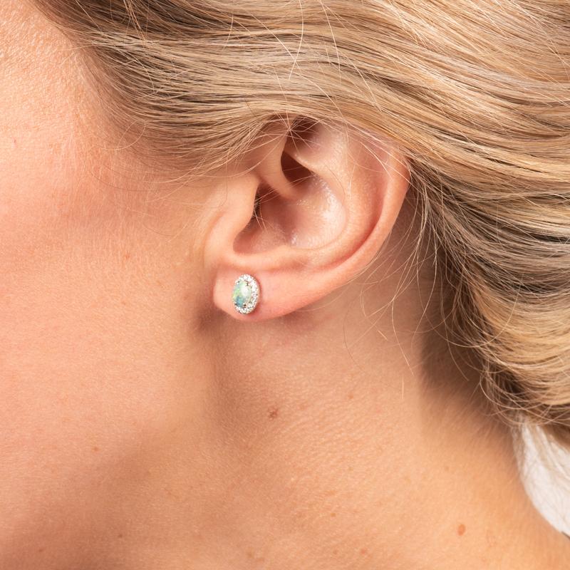 These stud earrings may be petite but they pack a beautiful punch as they sparkle and shine from every angle! They feature .74ctw of oval opals accented by .20ctw of round diamond pave set in 18 karat white gold. Each opal is sourced from the