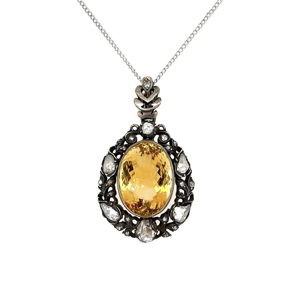 Simply Beautiful! Belle Époque Solitaire Citrine and Diamond Silver on Gold Pendant Necklace. Centering a securely nestled Hand set 7.5 Carat Citrine artfully surrounded by Diamonds, approx. 1.10tcw. Suspended from a14K White Gold Link Chain,