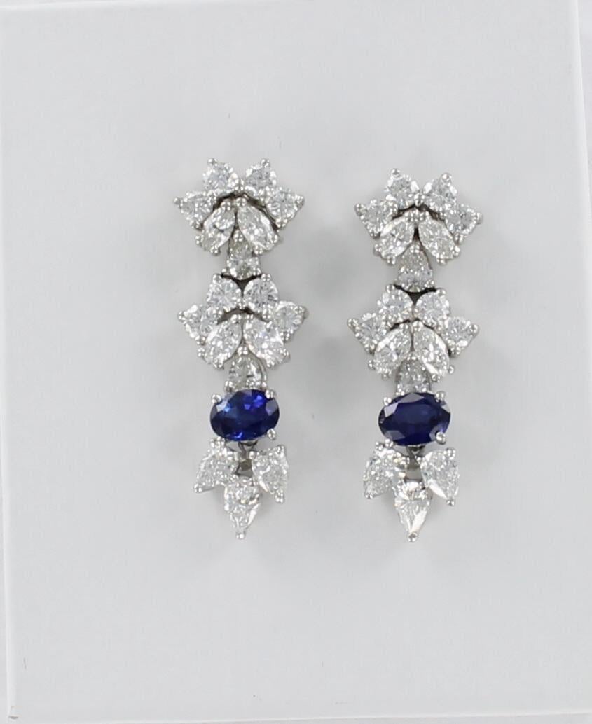 These platinum earrings will draw you to the dimensional sparkle delivered by the mix of Round, Marquis and Pear-shaped Diamonds. There are 7.5 carat total weight of diamonds in the 3 descending sections of the earrings. In the bottom section is a