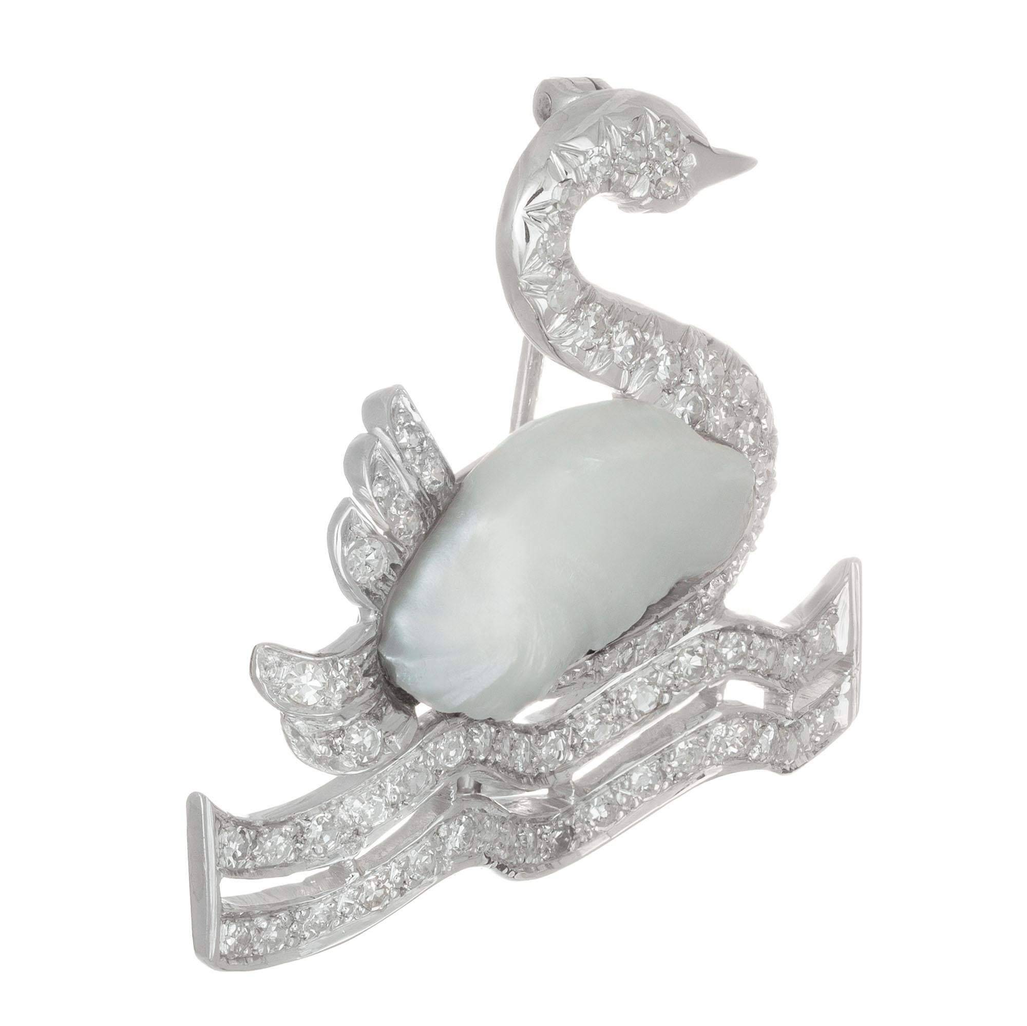 Mid-Century natural freshwater pearl and pave diamond Swan brooch in 14k white gold.

1 freshwater white grayish pearl 16.9 x 8mm
67 single cut diamond H-J SI-I, approx. .75ct
14k white gold 
5.9 grams
Top to bottom: 28.56 or 1 1/8 Inch
Width: