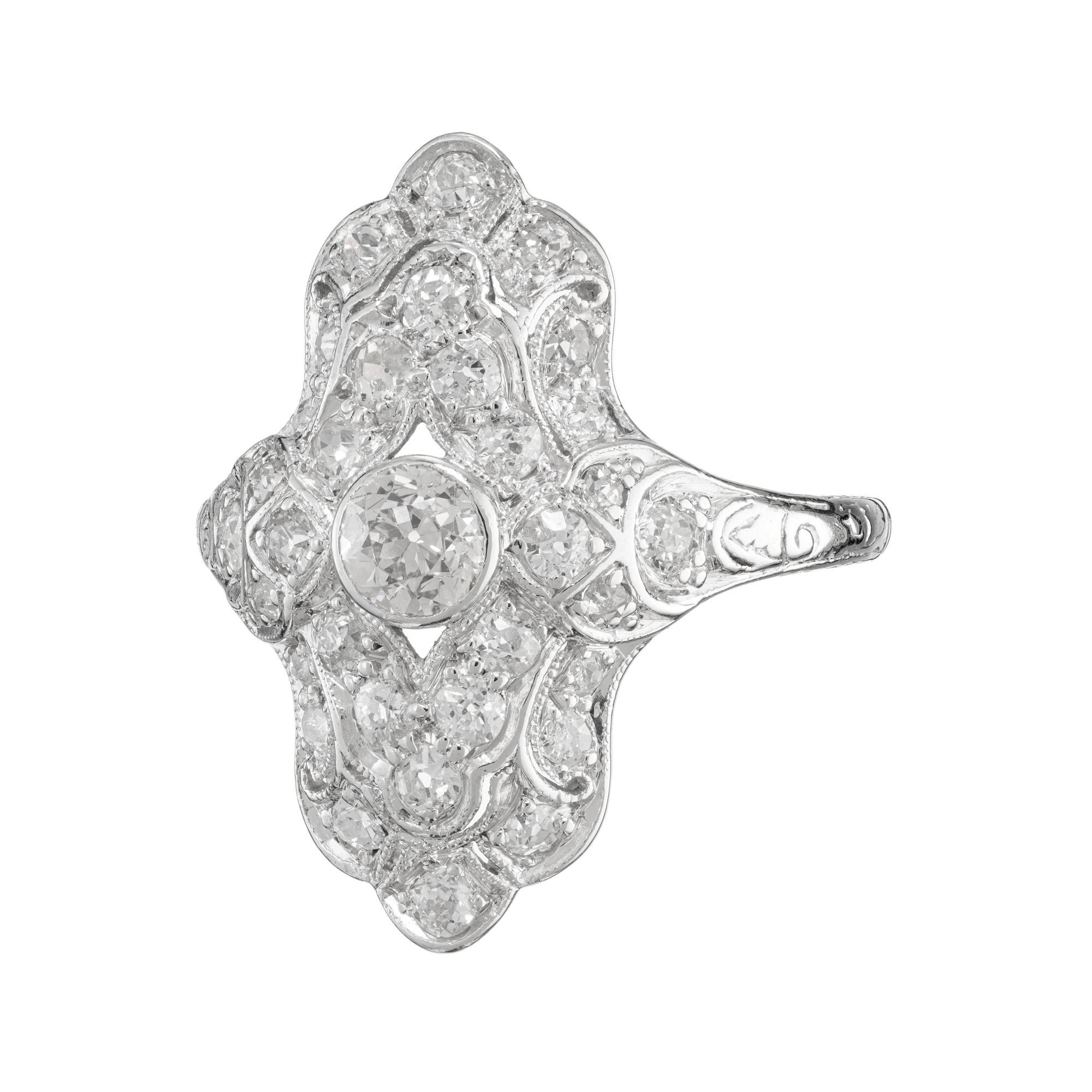 Mid 1920's diamond cocktail dinner ring. Exquisite in detail, this Art Deco ring is set with a .25ct old mine center stone, which is adorned with 32 old mine cut diamonds totaling .50cts. The center diamond is bezel set and surrounded with beading