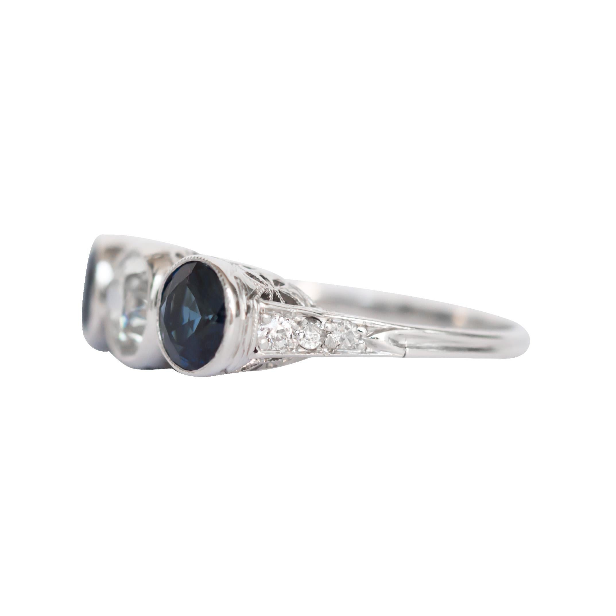 Ring Size: 6.5
Metal Type: Platinum 
Weight: 4.1 grams

Center Diamond Details
Shape: Old European Brilliant 
Carat Weight: .75 carat
Color: I
Clarity: VS1

Side Stone Details: 
Type: Natural Sapphire 
Shape: Round Brilliant 
Total Carat Weight:
