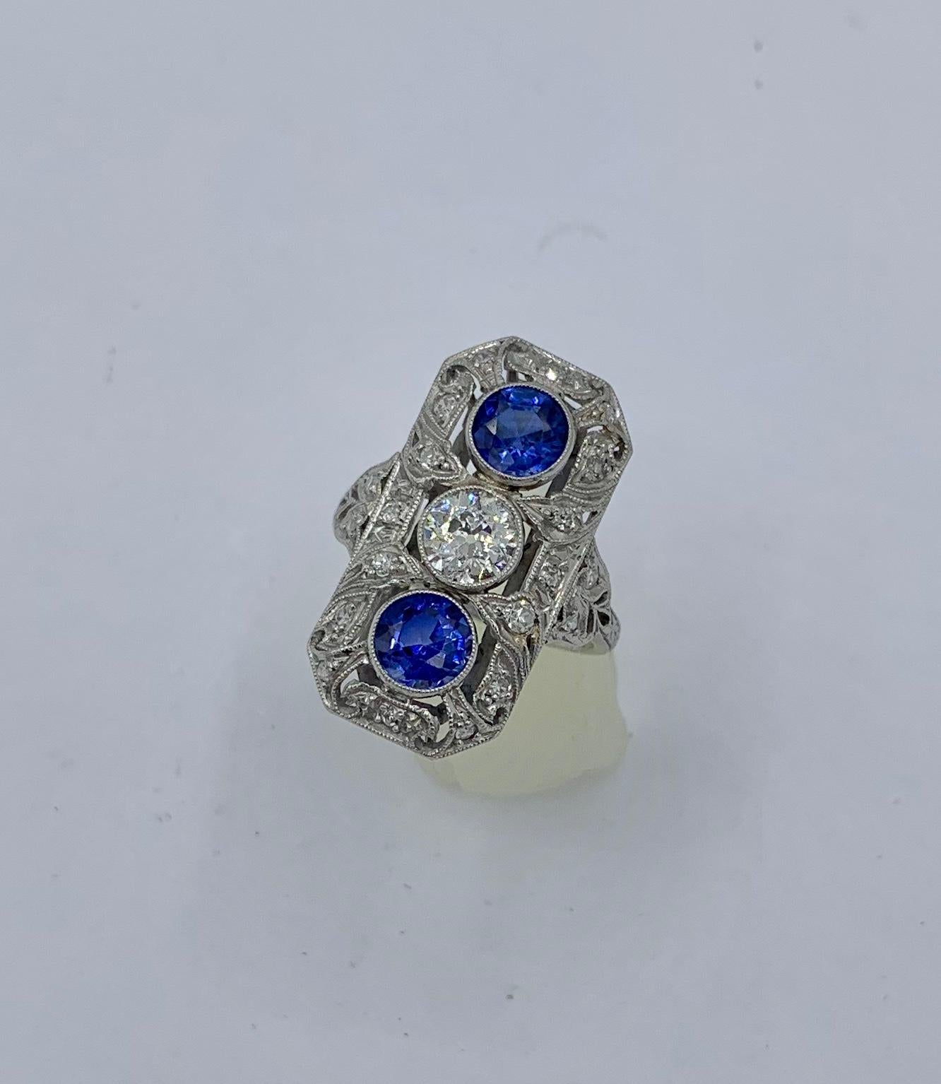 This is an absolutely stunning Diamond Sapphire Platinum Antique Art Deco - Victorian Wedding Engagement Ring.  The rectangular panel design Platinum setting is gorgeous with exquisite open work, milgrain beaded borders, and set throughout with
