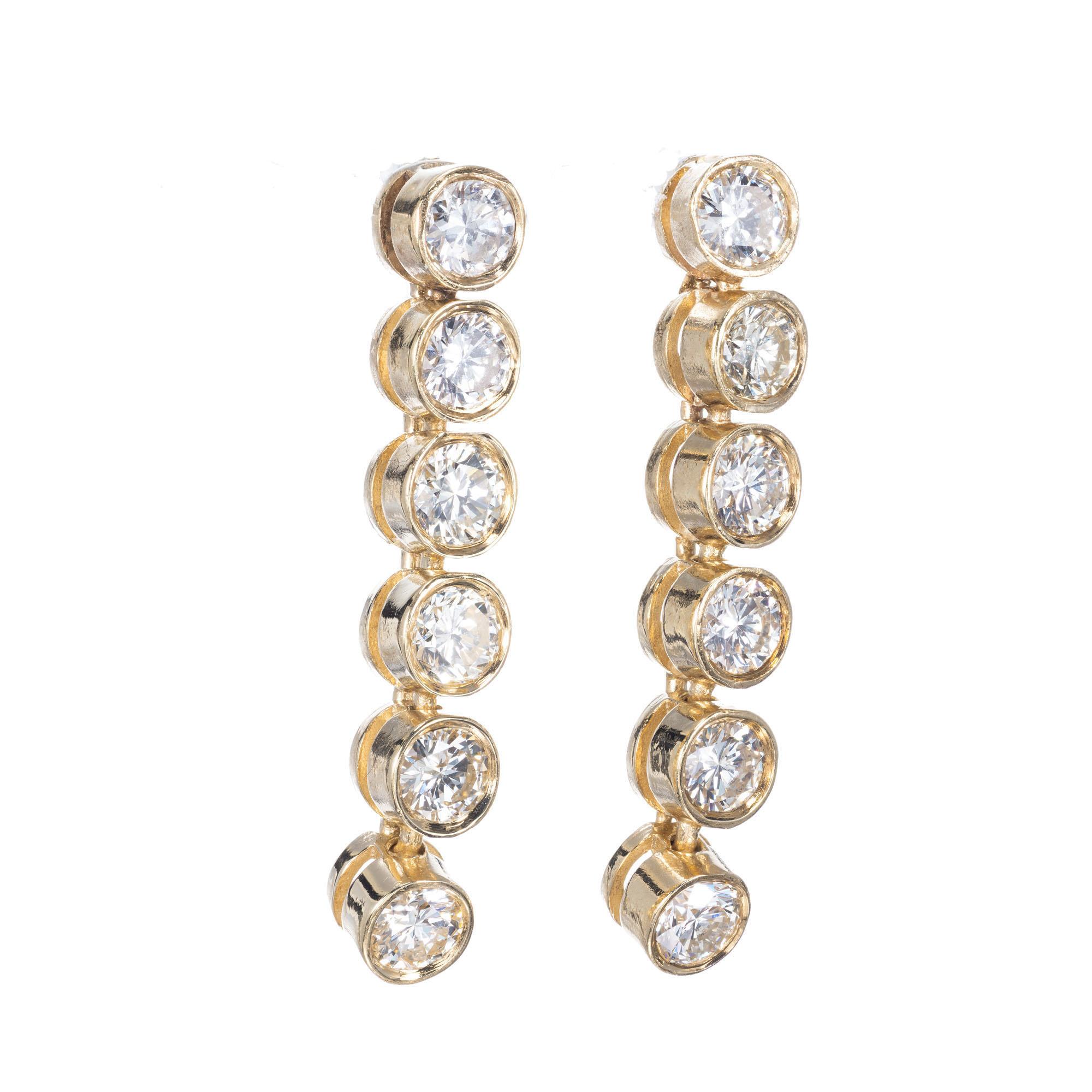 One Inch long tube set diamond dangle earrings with post tops set with nice full cut diamonds. 

12 full cut diamonds, .07ct each, approx. total weight .75ct
14k yellow gold 
Tested: 14k
3.5 grams
Top to bottom: 25mm or 1 inch
Width: 4mm
Depth: