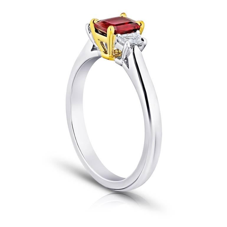 .75 Carat Emerald Cut (natural no heat) Red Ruby with 2 trapezoid cut diamonds .28 carats set in a platinum and 18k yellow gold ring.
