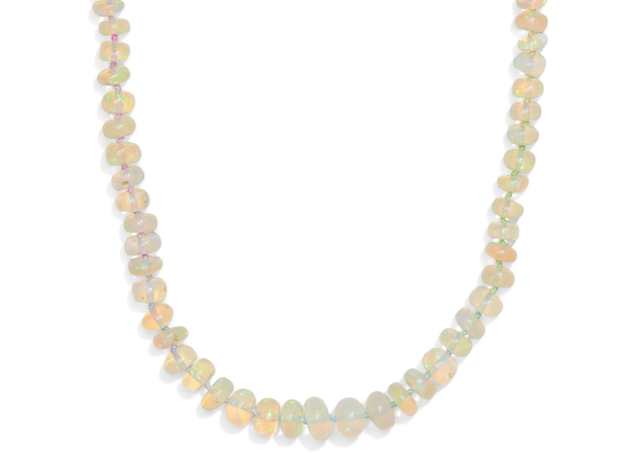 Breathtaking sparkling creamy white sparkling Welo opal necklace, hand knotted on multicolor silk thread that capture all colors of the rainbow. The opals discplay a breathtaking play of colors, vary from yellow, pink and orange to a purplish blue.