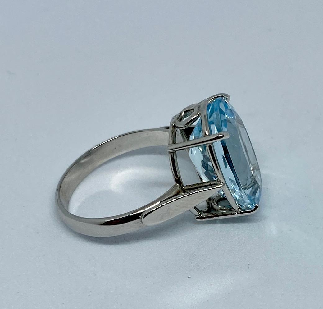 A classic ring, breathtaking in the simplicity of its design, color and proportions. 

Set in 18K white gold, the faceted, light blue stone measures a little over 16 by 12 mm and weighs 7.5 carats. 

The size 6.5 white gold band is stamped 