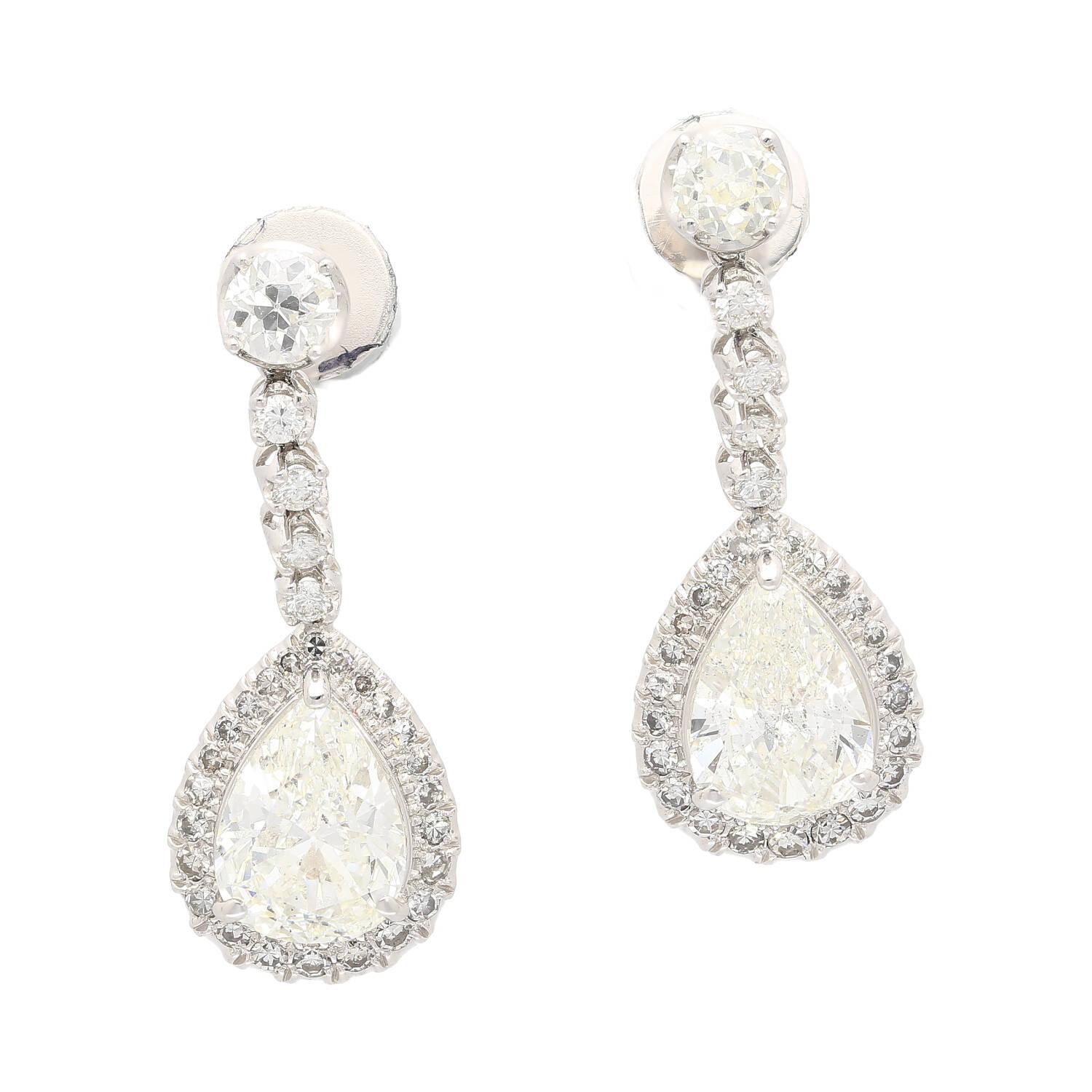 Adorn yourself with these luxurious drop earrings crafted from 18K white gold. The contemporary design and prong setting gives the elegantly shimmering natural diamonds of 7.51 carats a beautiful and radiant presence, weighing in at 7.72 grams and