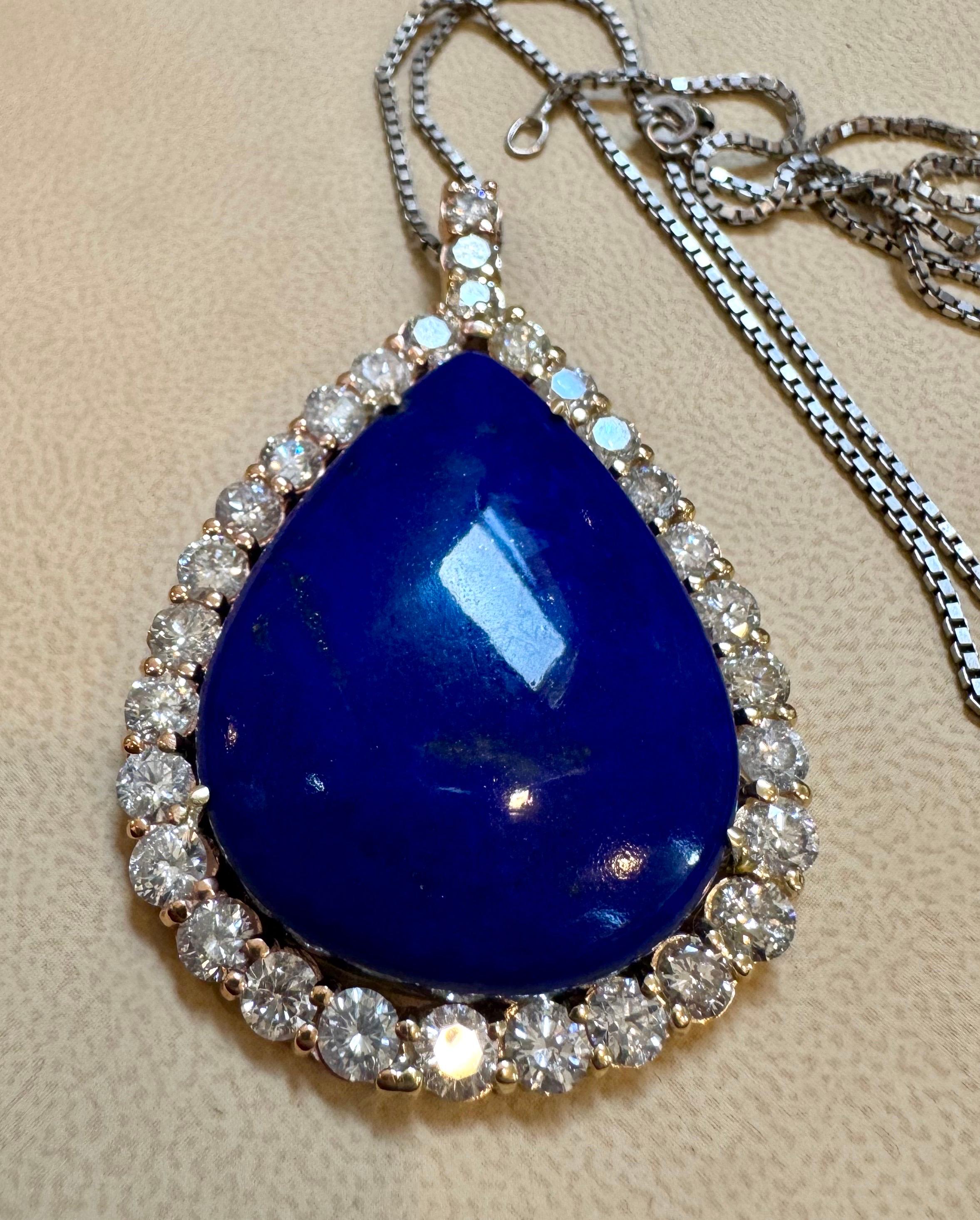   Approximately  75 Carat Lapis & 9.5 Ct Diamond Pendant Necklace 14 Karat White Gold + Chain
This spectacular Pendant Necklace  consisting of a single large Pear Lapis , approximately  75 Carat.  The  Lapis  Has brilliant cut diamonds around it 
