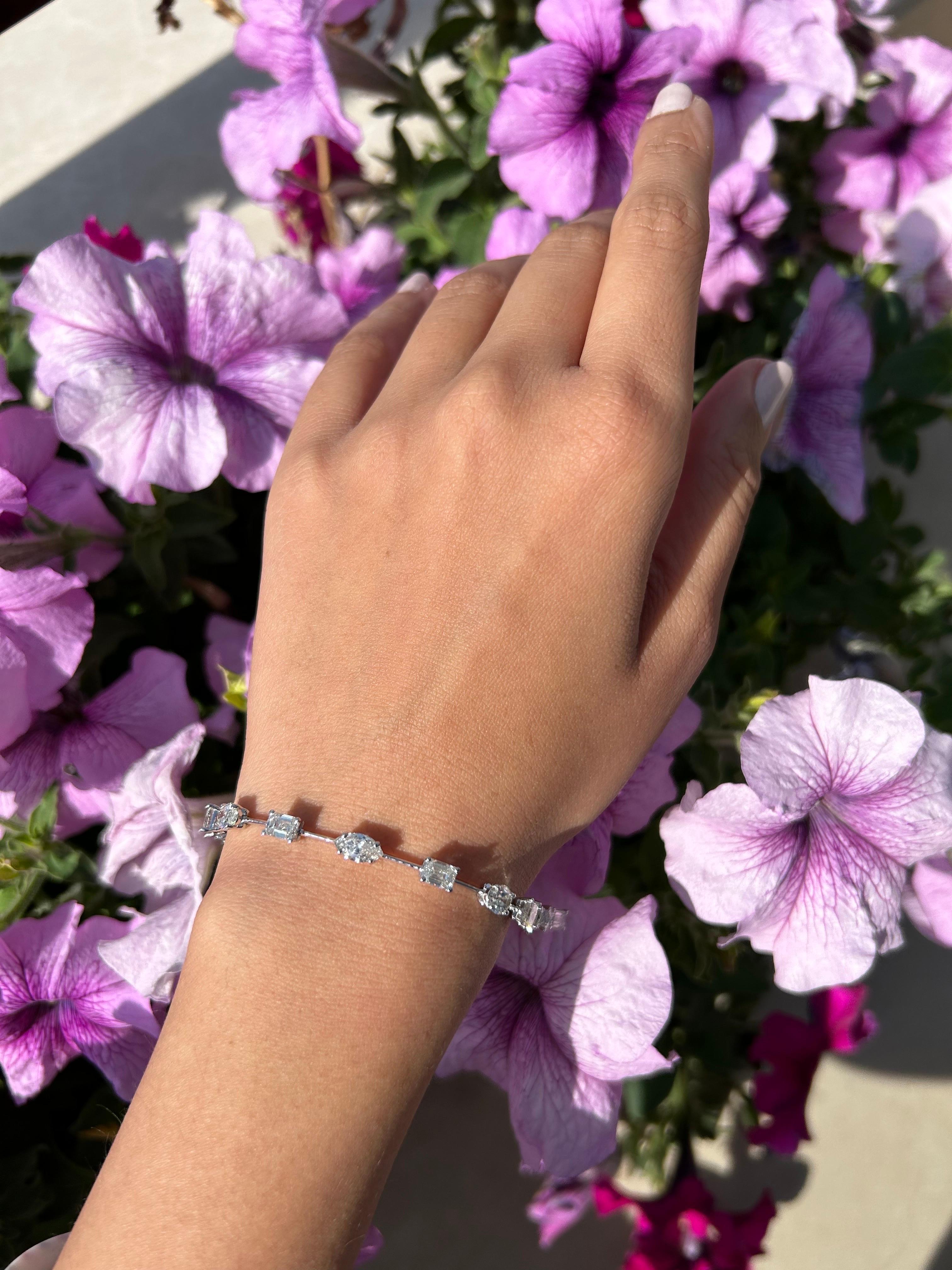 A twist to a classic tennis bracelet, with mixed shape White Diamonds weighing 0.5 carats each. There are a total of 13 VS quality, G/H color White Diamonds, set in 18K White Gold. The length of the bracelet is currently 6 inches, can be