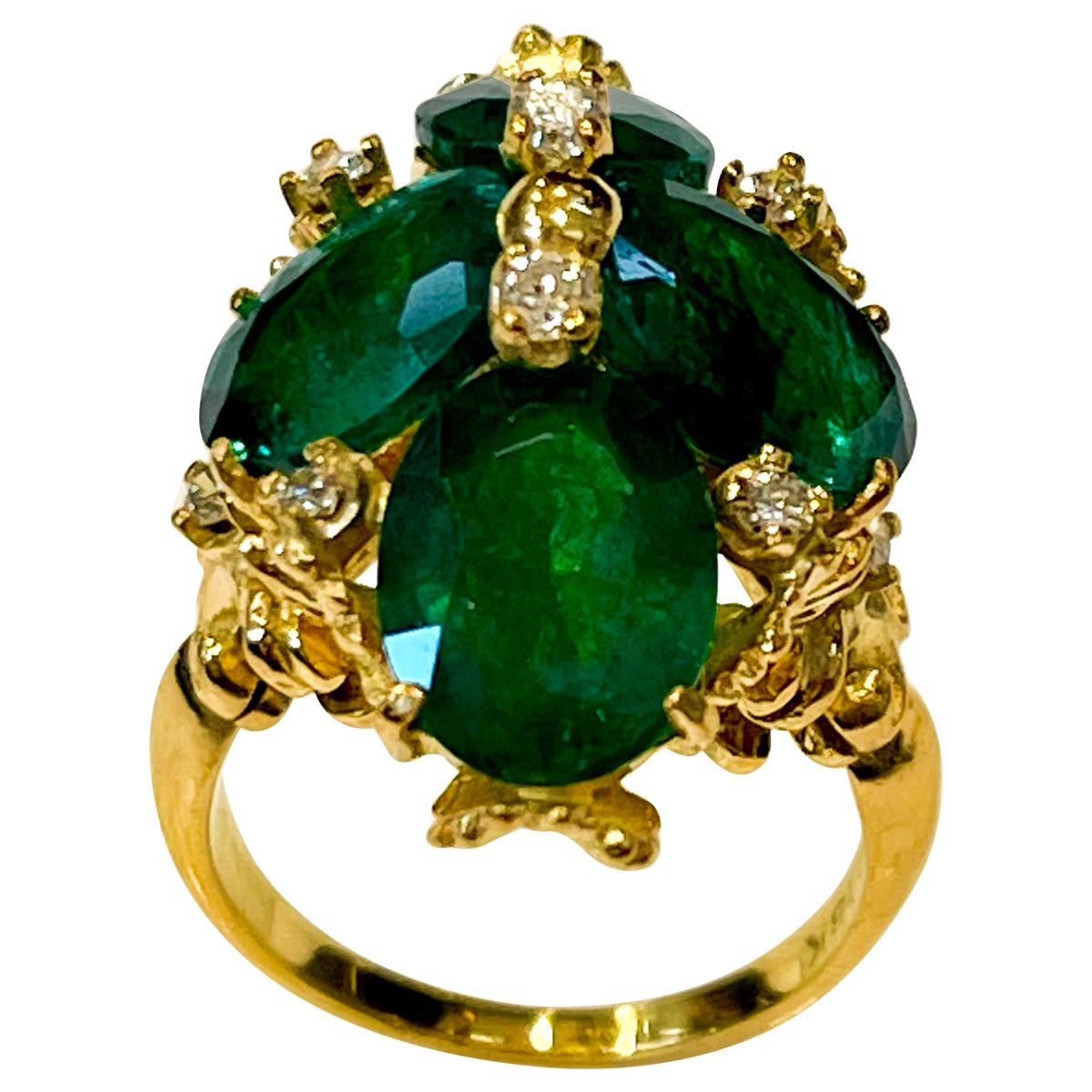 A classic, Cocktail ring 
7.5 Carat Natural 4 Oval Cut Emerald & Diamond Flower Ring 18 Karat Yellow Gold 
Beautiful design of gold at the back of the ring
Large size Oval cut Emerald Intense green color with lots of shine and brilliance but has