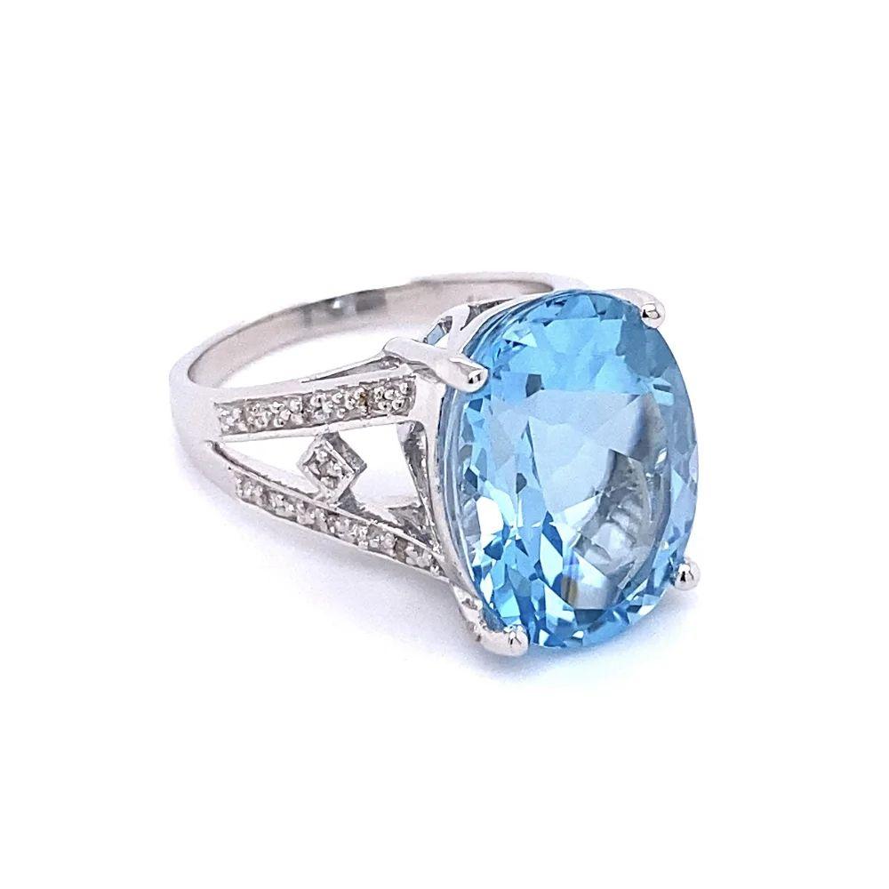 Simply Beautiful! Vintage Oscar Worthy Oval Blue Topaz Solitaire Cocktail Gold Ring. Centering a securely nestled Hand set Impressive Oval Blue Topaz, weighing approx. 7.5 Carats. Accented either side with Diamonds, approx. .05tcw. Finely