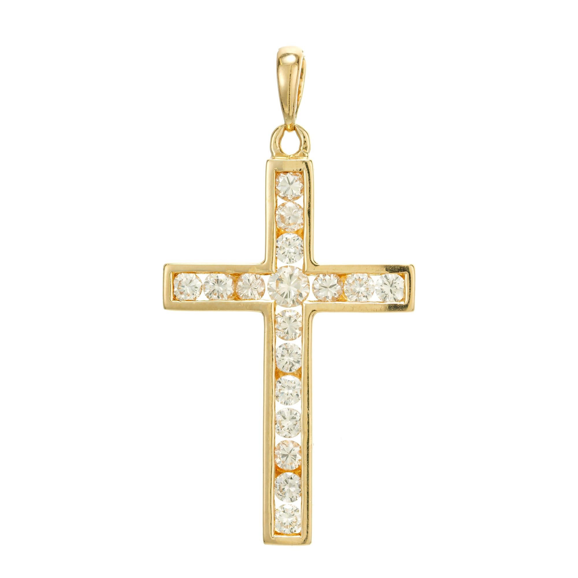 Open channel set cross with 17 round brilliant cut diamonds in 14k yellow gold.

17 round brilliant cut diamonds, I SI approx. .75cts
14k yellow gold 
Stamped: 14k
3.7 grams
Top to bottom: 39.2mm or  1.5 Inches
Width: 20.3mm or .80 Inches
Depth or