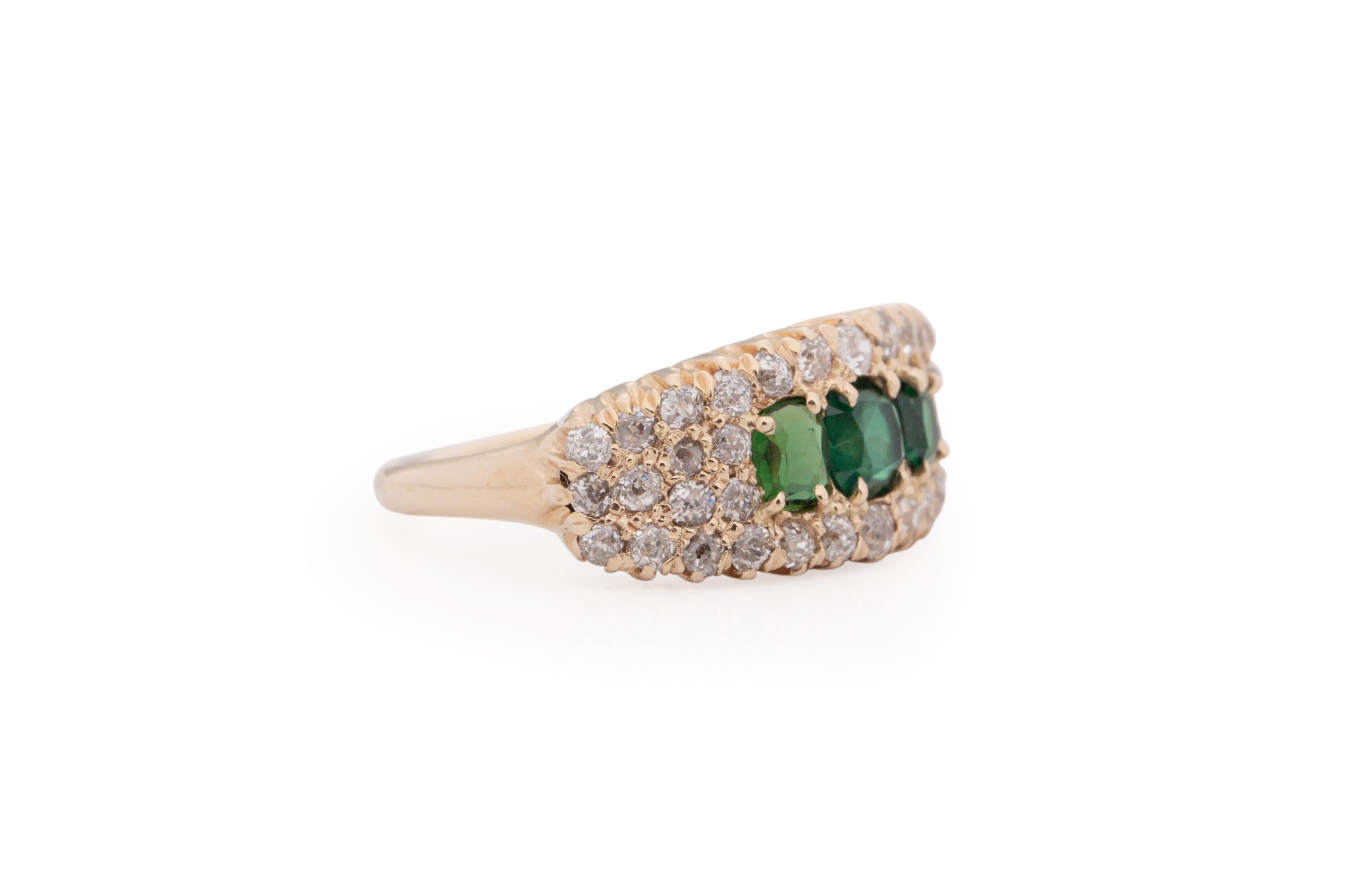 Ring Size: 6.75
Metal Type: 14 Karat Yellow Gold [Hallmarked, and Tested]
Weight: 5.4 grams

Diamond Details:
Weight: 1.00 carat
Cut: Old Mine Brilliant
Color: G-H-I
Clarity: VS/SI

3 Stone Details:
Type: Emerald (Synthetic)
Weight: .75 carat total