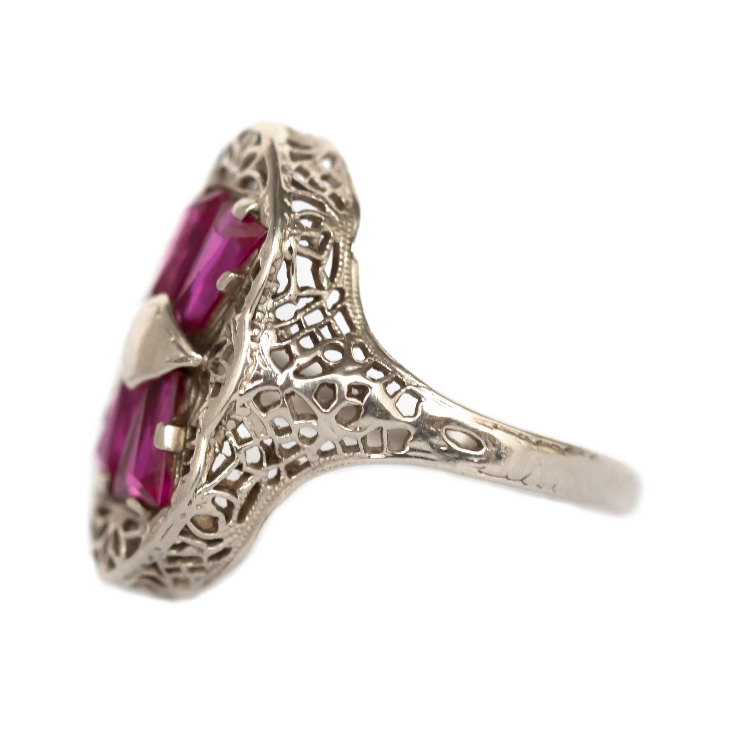 Item Details: 
Ring Size: 8.25
Metal Type: 14 Karat White Gold 
Weight: 2.9 grams

Color Stone Details: 
Type: Synthetic Ruby
Shape: Tapered Step Cut
Carat Weight: .75 carat, total weight.
Color: Deep Red

Finger to Top of Stone Measurement: 5.79mm